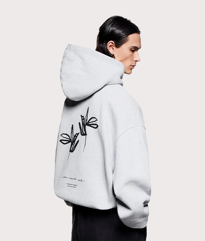 MKI MIYUKI ZOKU Relaxed Fit Ink Flower Hoodie in Grey at EQVVS Menswear. Angled model front shot.