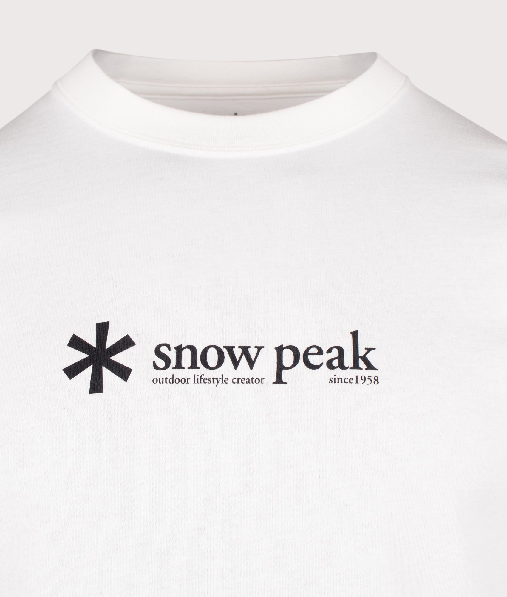 Snow Peak Soft Cotton Logo Long Sleeve T-Shirt in White at EQVVS Menswear. Detail shot.