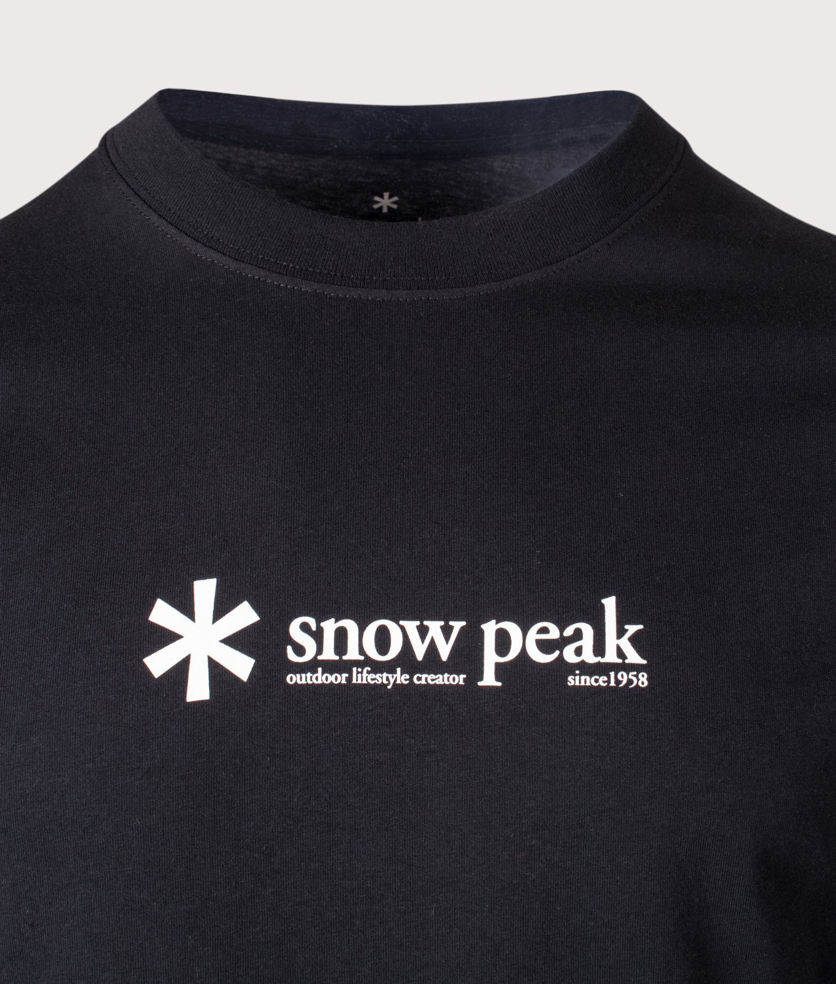 Snow Peak Soft Cotton Logo Long Sleeve T-Shirt in Black at EQVVS Menswear. Detail shot.