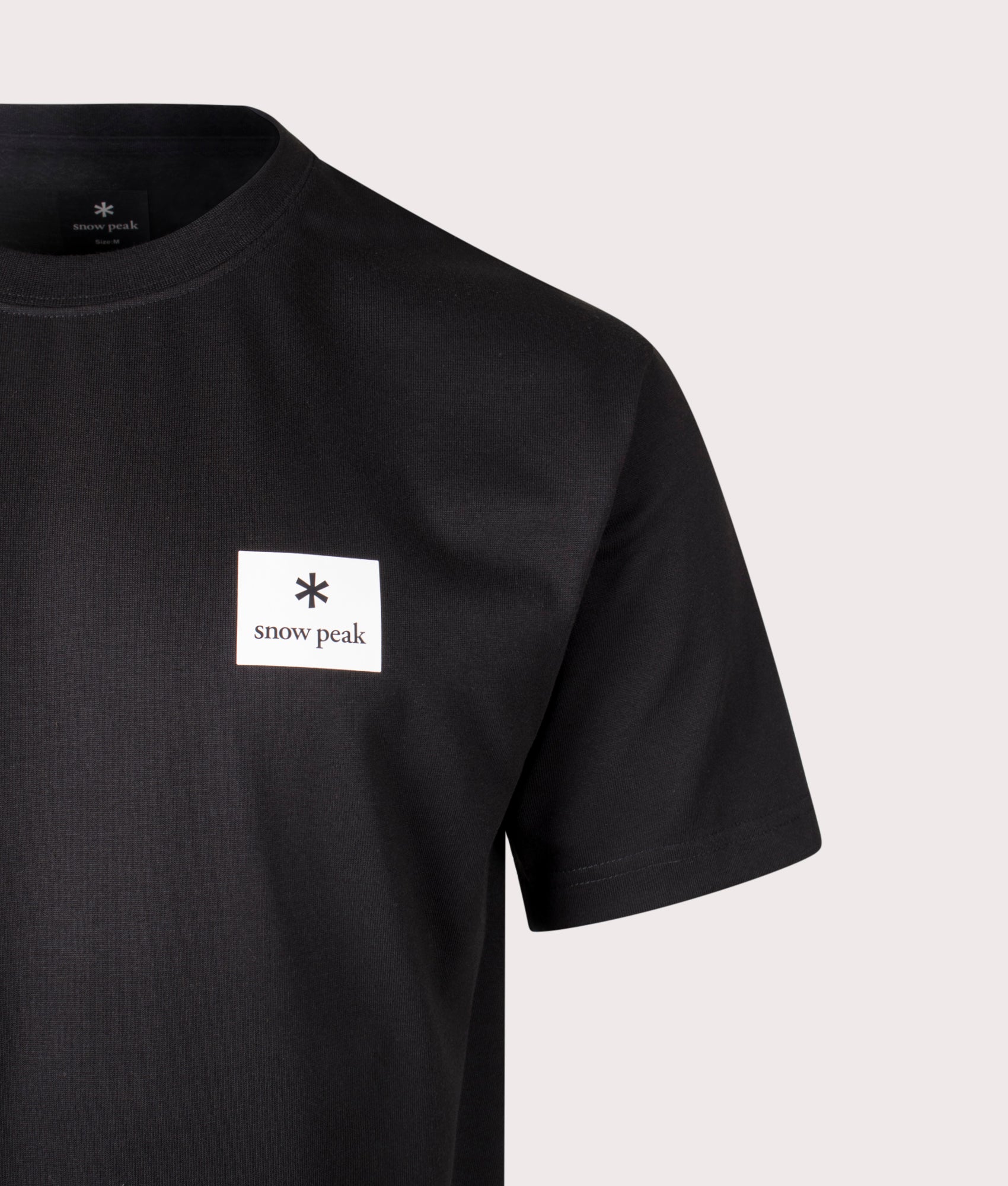 New Standard Square Logo T-Shirt in Black. Cotton blend | Snow Peak | Shot at EQVVS | Front detail shot 