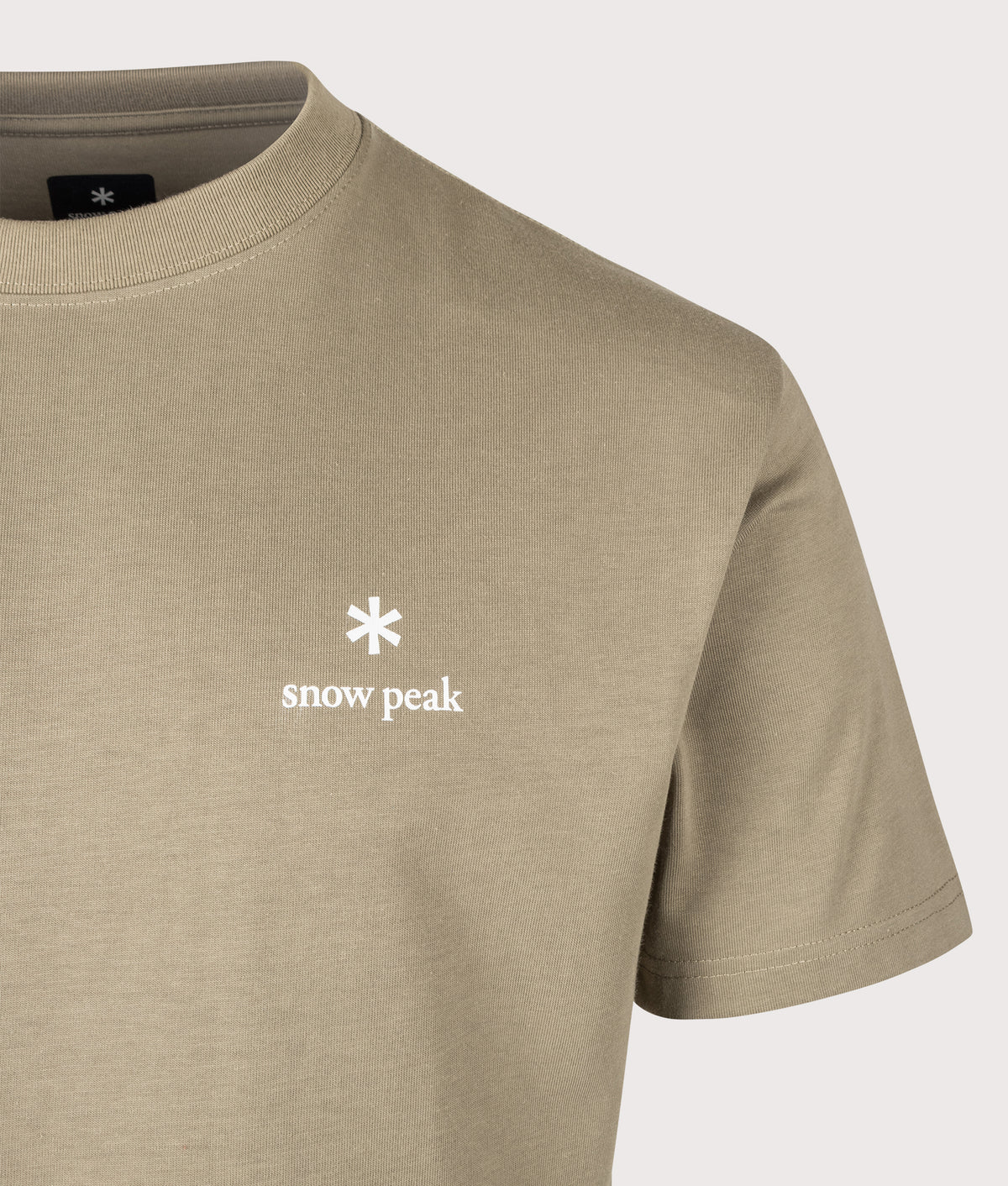 Snow Peak Relaxed Fit New Standard Logo T-Shirt in Dark Beige at EQVVS Menswear. Detail shot.