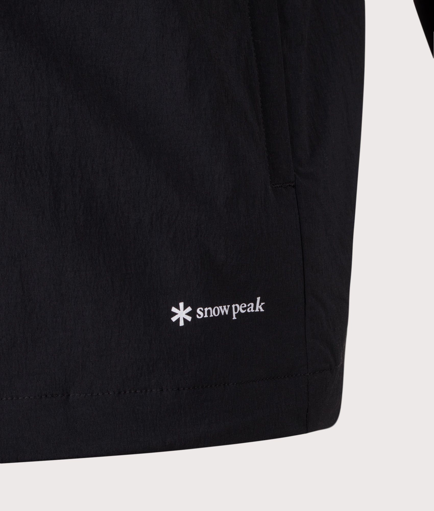 Snow Peak Relaxed Fit New Standard Utility Parka in Black at EQVVS Menswear. Detail shot.