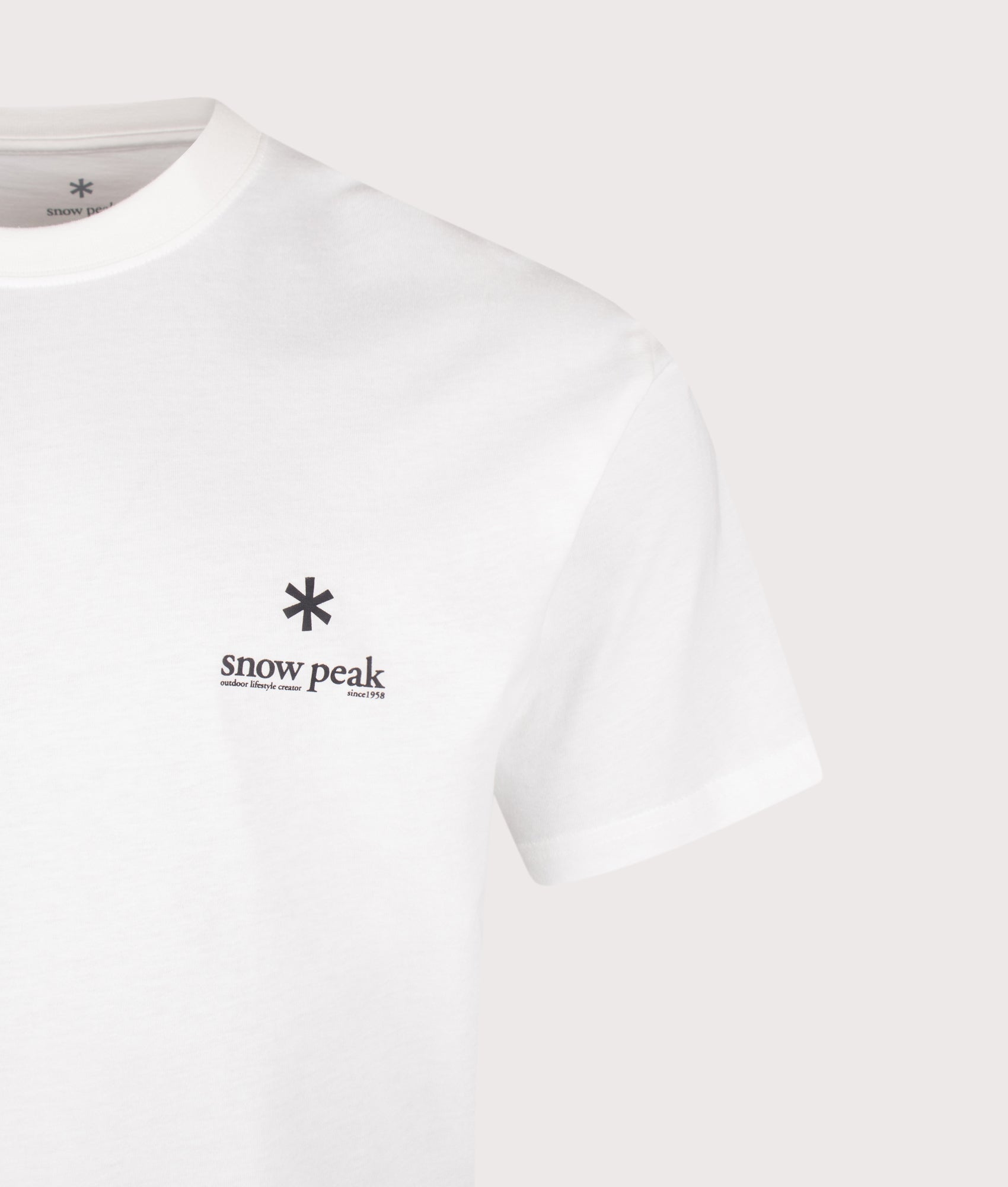 Snow Peak Relaxed Fit Soft Cotton Logo T-Shirt in Off White at EQVVS Menswear. Detail shot.