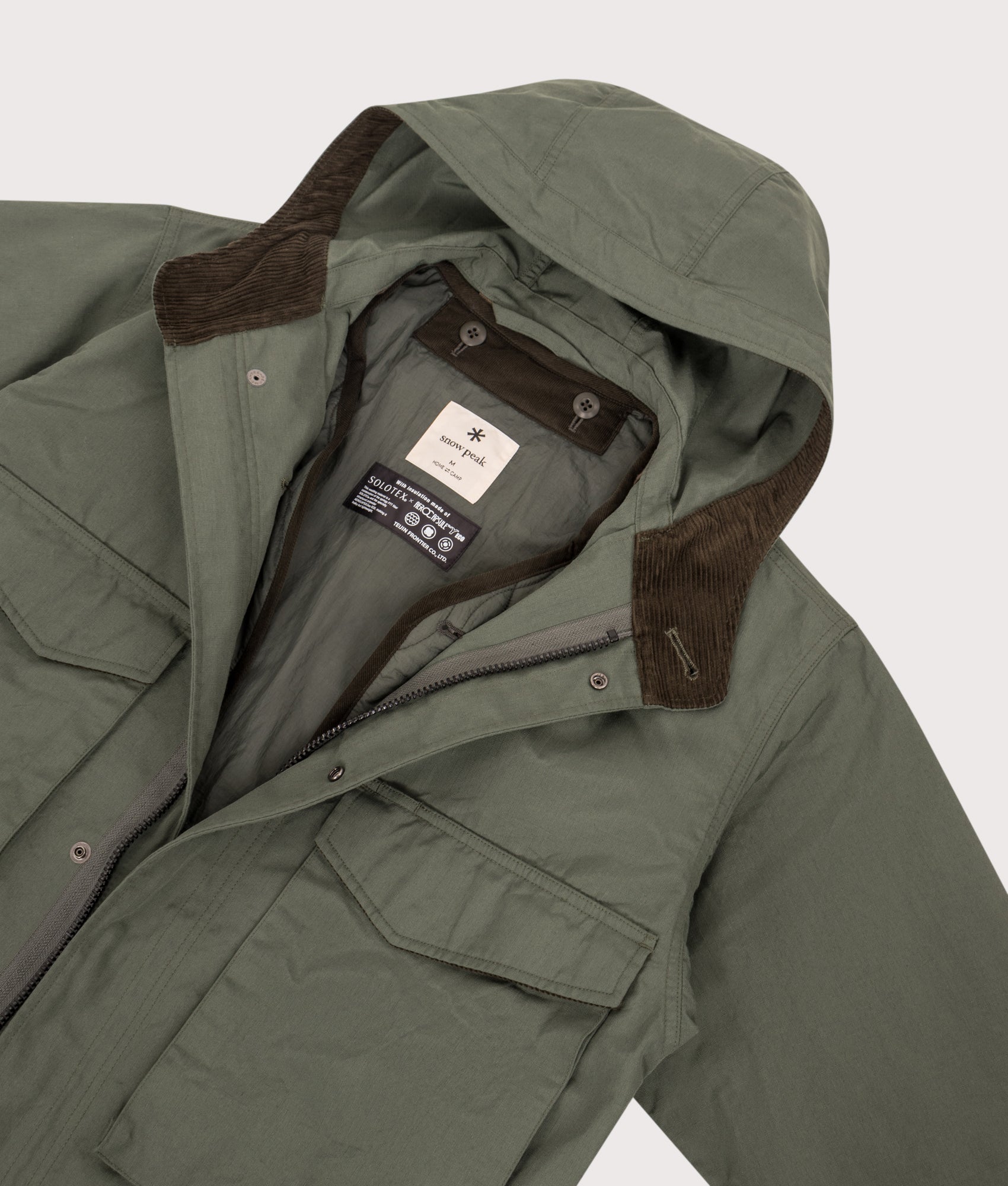 Snow Peak TAKIBI Ripstop Adjustable Jacket in Olive at EQVVS Menswear. Detail shot.