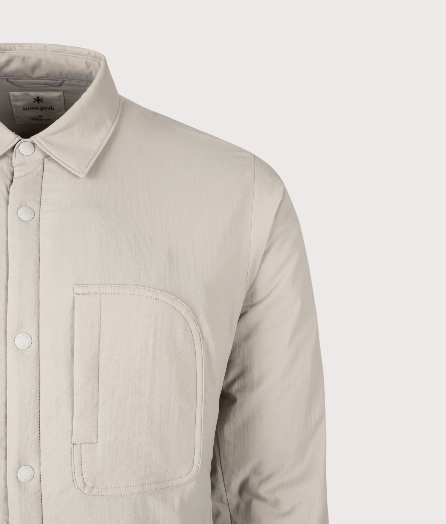 Snow Peak Flexible Insulated Shirt in Greige at EQVVS Menswear. Detail shot.