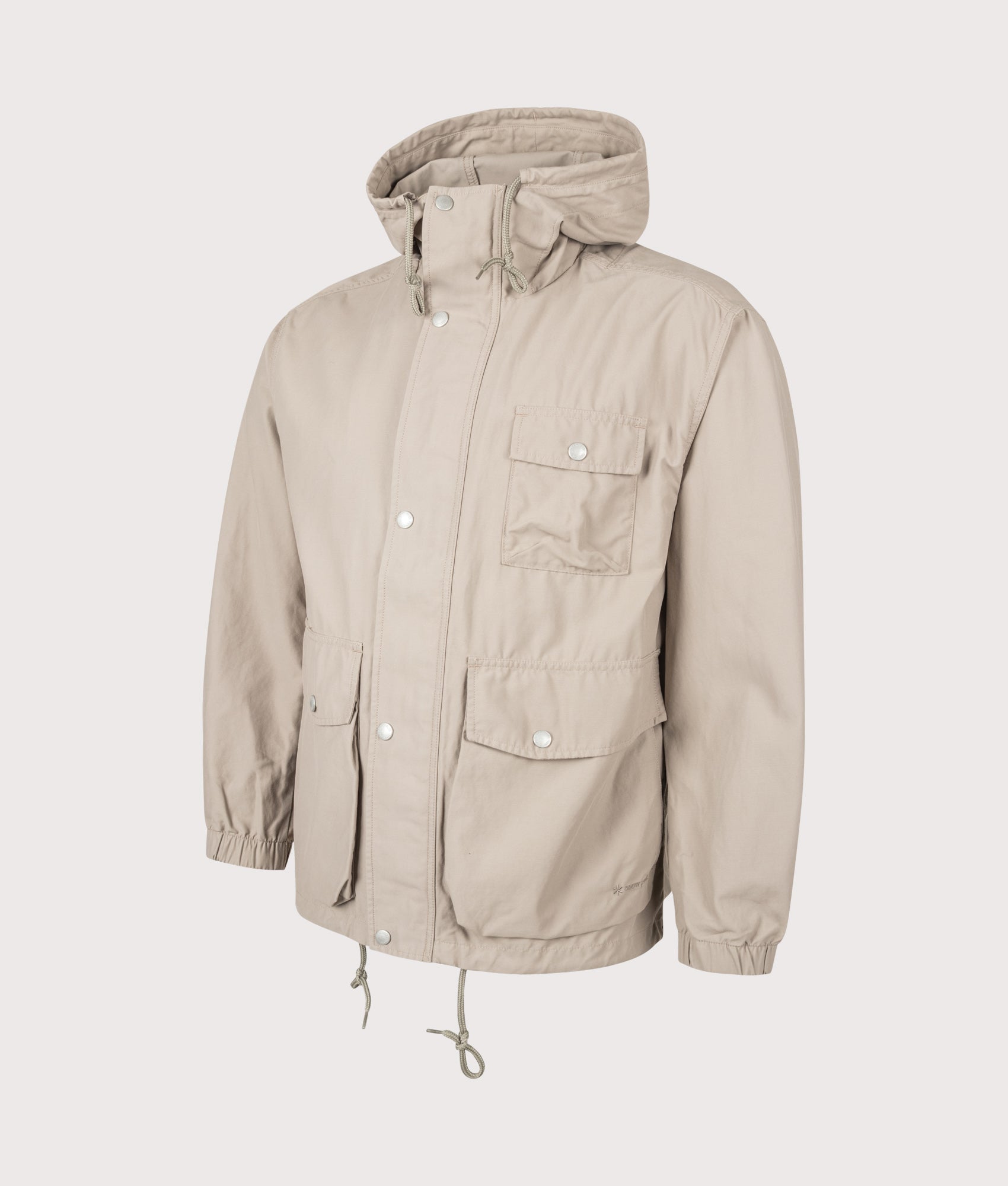 Snow Peak Light Dobby Cloth Parka in Greige at EQVVS Menswear. Angled front shot.