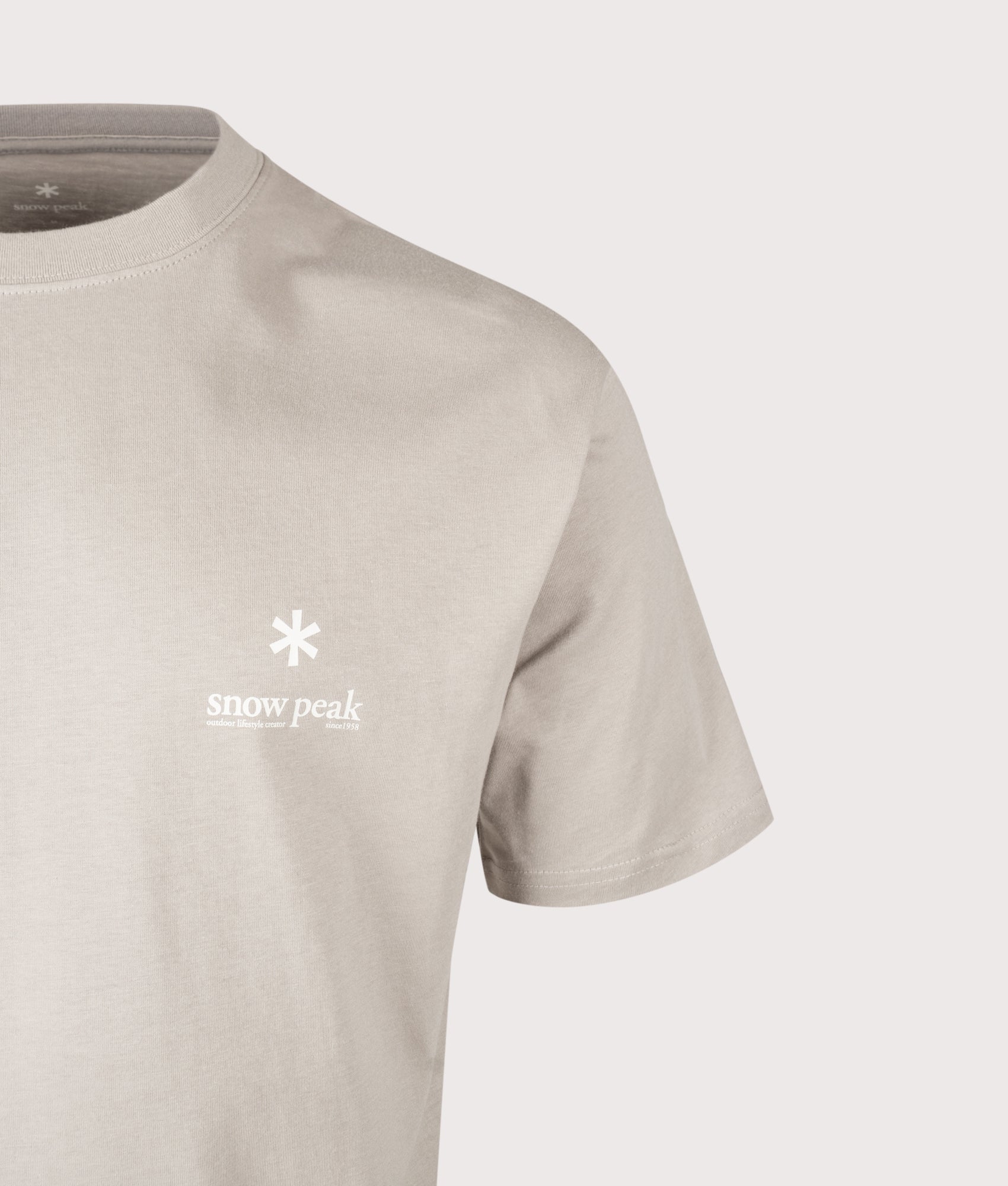Snow Peak Relaxed Fit Soft Cotton Logo T-Shirt in Greige at EQVVS Menswear. Detail shot.