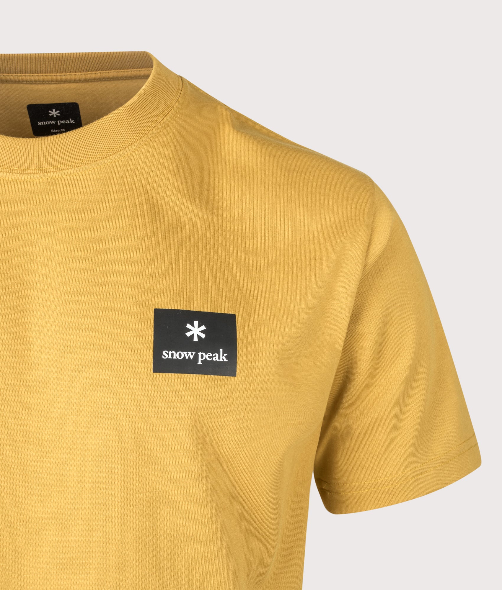 Snow Peak New Standard Square Logo T-Shirt in Yellow at EQVVS Menswear. Detail shot.