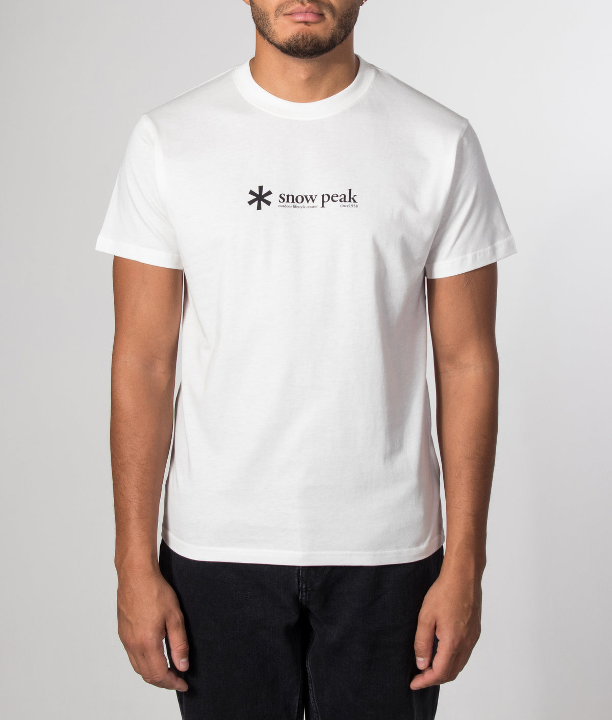 Snow Peak Regular Fit Soft Cotton Logo T-Shirt in Off White at EQVVS Menswear.  Model front shot.