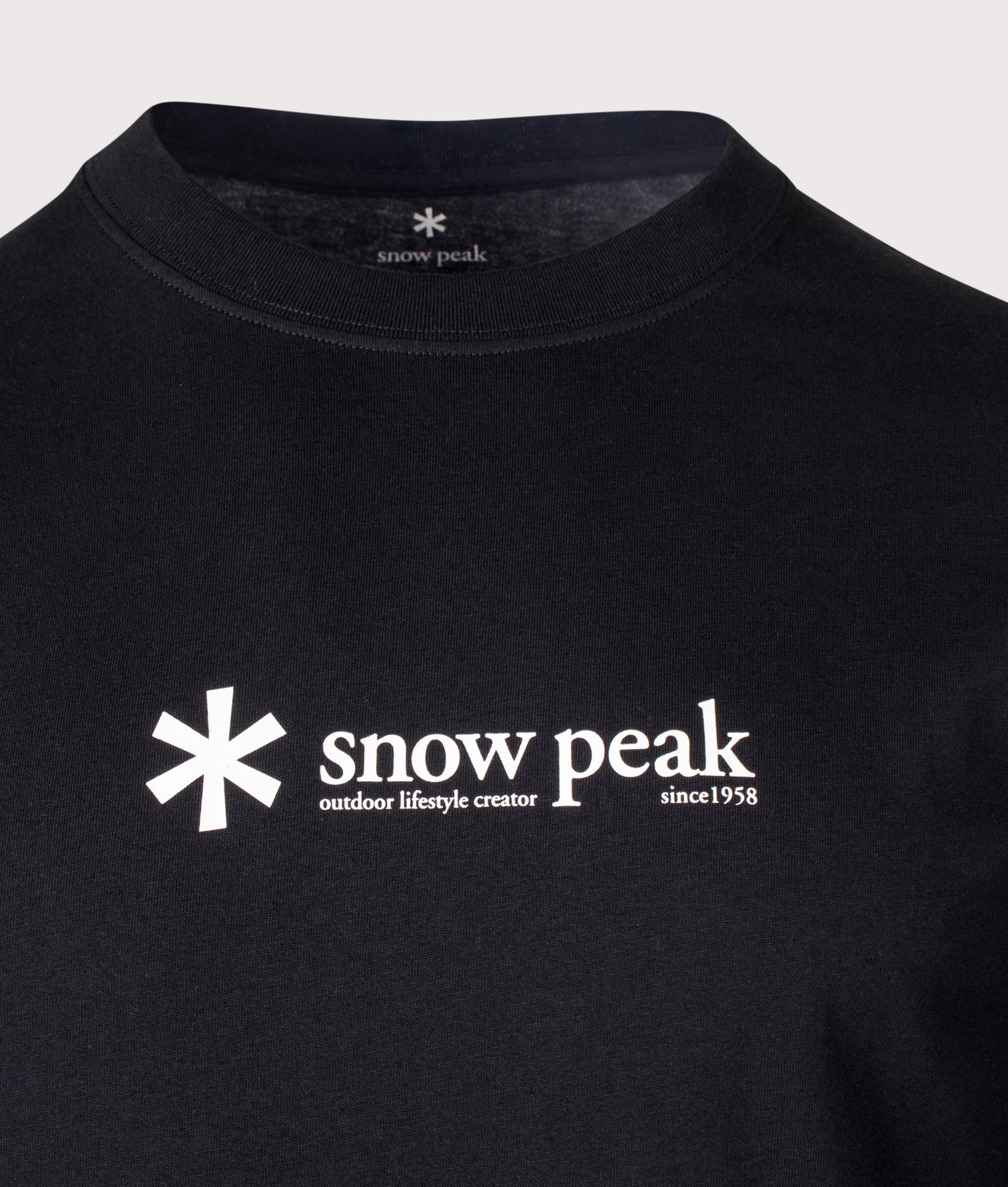 Snow Peak Regular Fit Soft Cotton Logo Long Sleeve T-Shirt in Black at EQVVS Menswear. Detail shot.