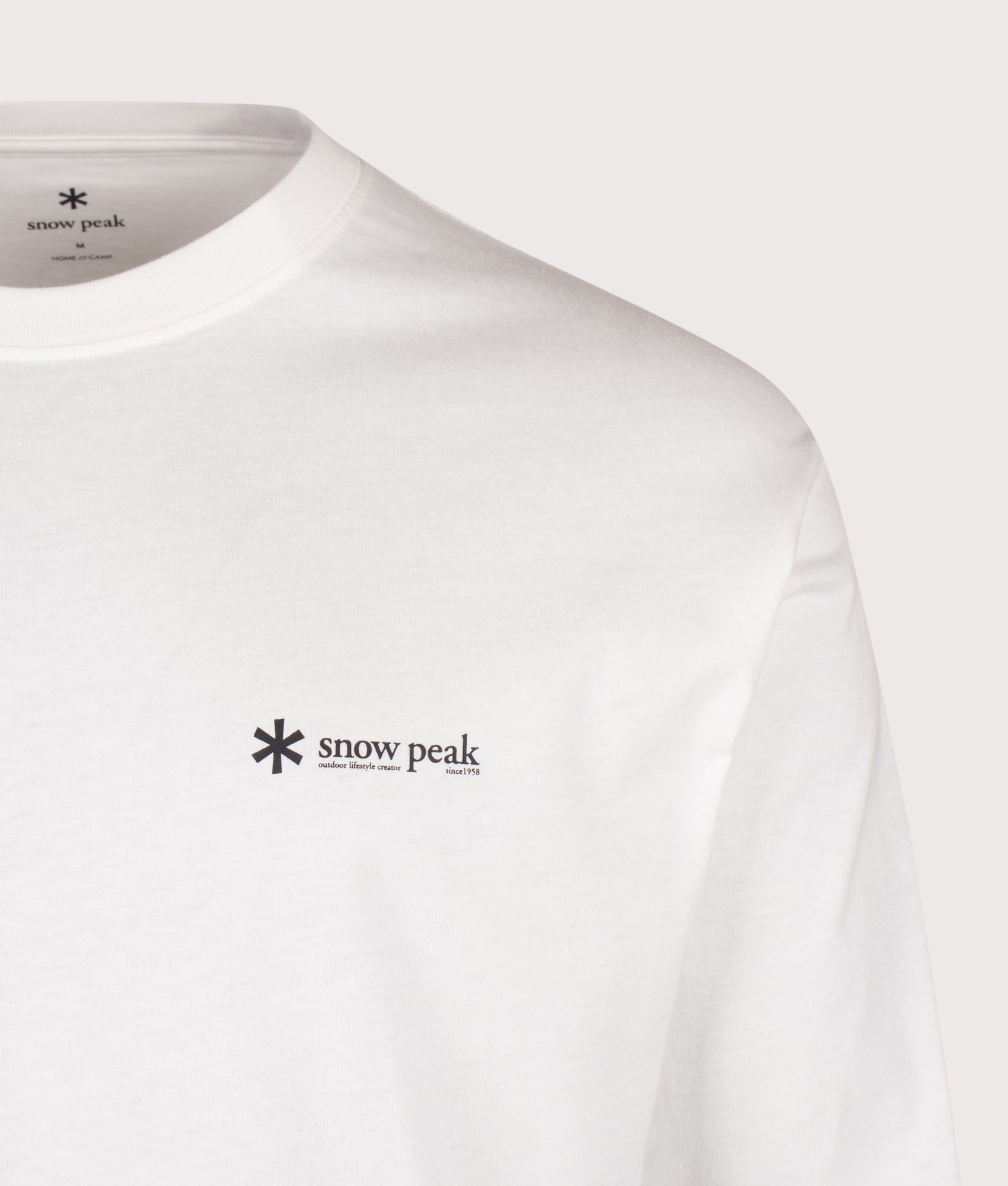 Snow Peak Relaxed Fit Long Sleeve Logo T-Shirt in Off White at EQVVS Menswear. Detail shot.