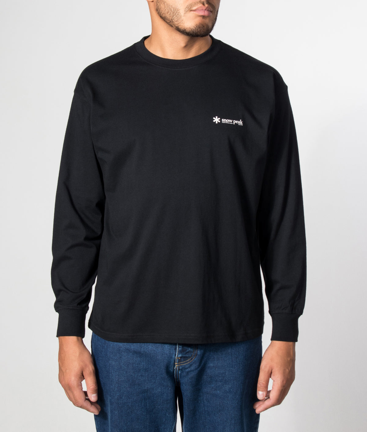 Snow Peak Relaxed Fit Long Sleeve Logo T-Shirt in Black at EQVVS Menswear. Model front shot.