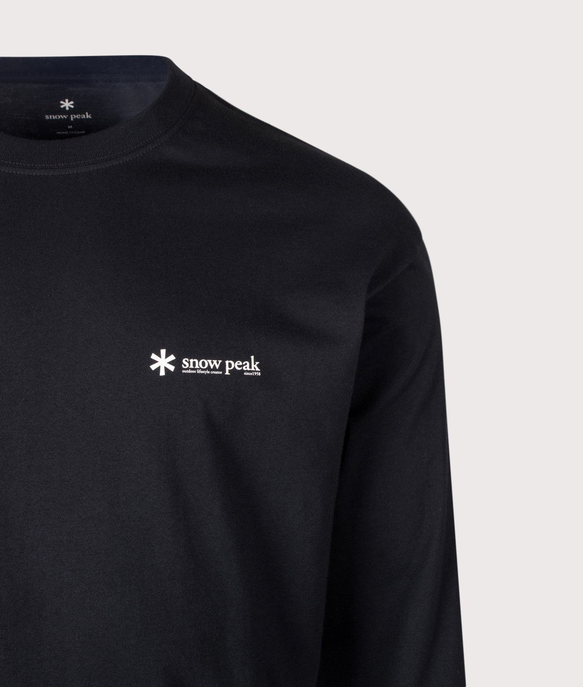 Snow Peak Relaxed Fit Long Sleeve Logo T-Shirt in Black at EQVVS Menswear. Detail shot.