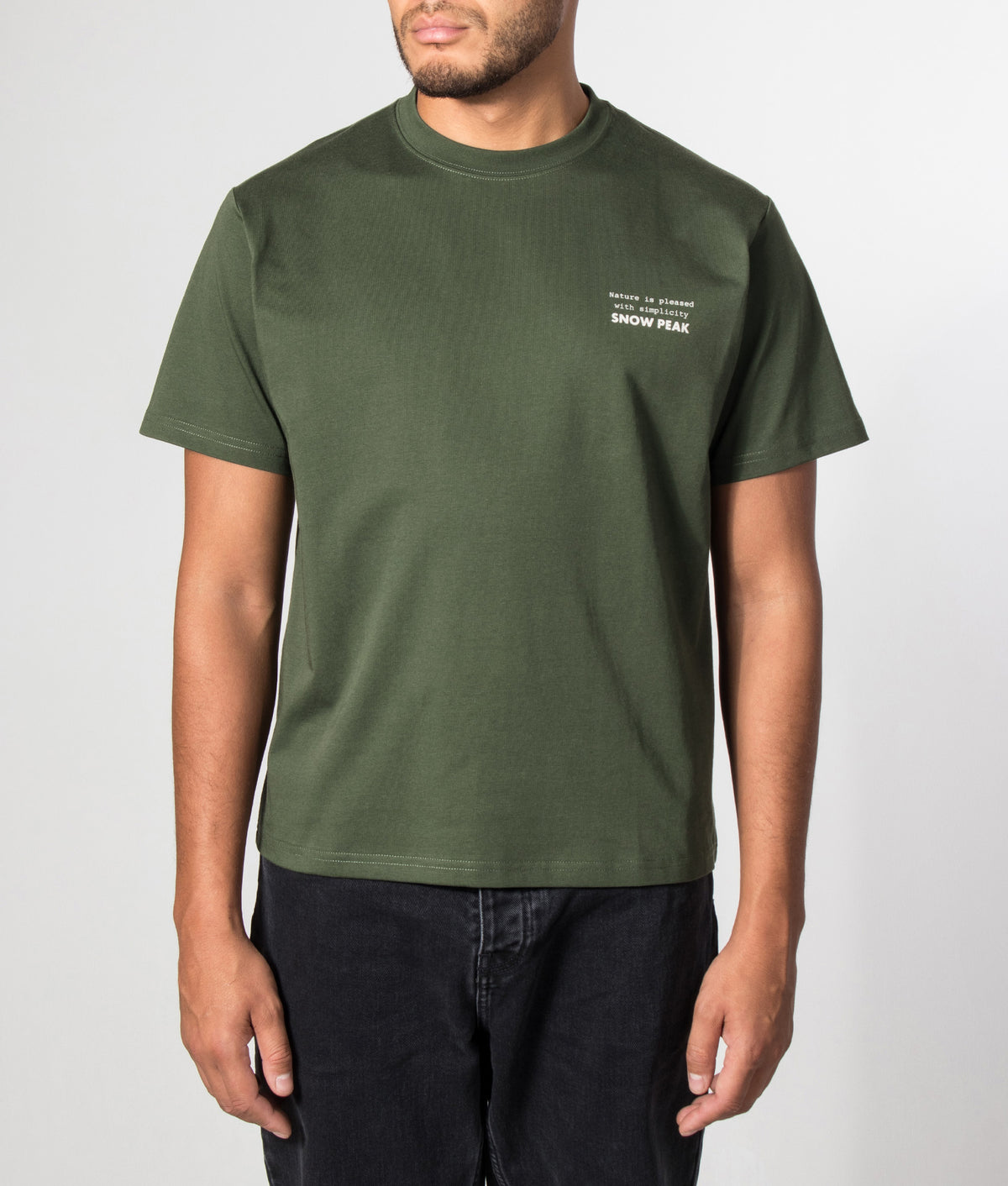Snow Peak Relaxed Fit Elemental Balance T-Shirt in Dark Green at EQVVS Menswear. Model front shot.