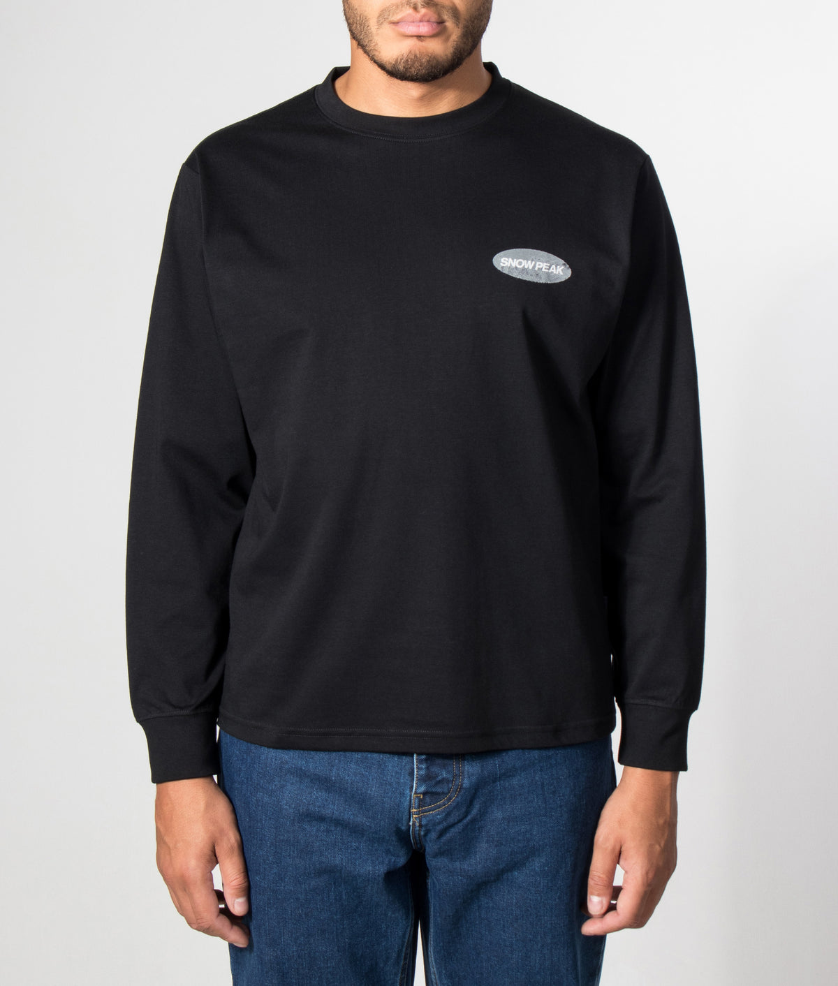 Snow Peak Relaxed Fit Campscape Long Sleeve T-Shirt in Black at EQVVS Menswear. Model front shot.