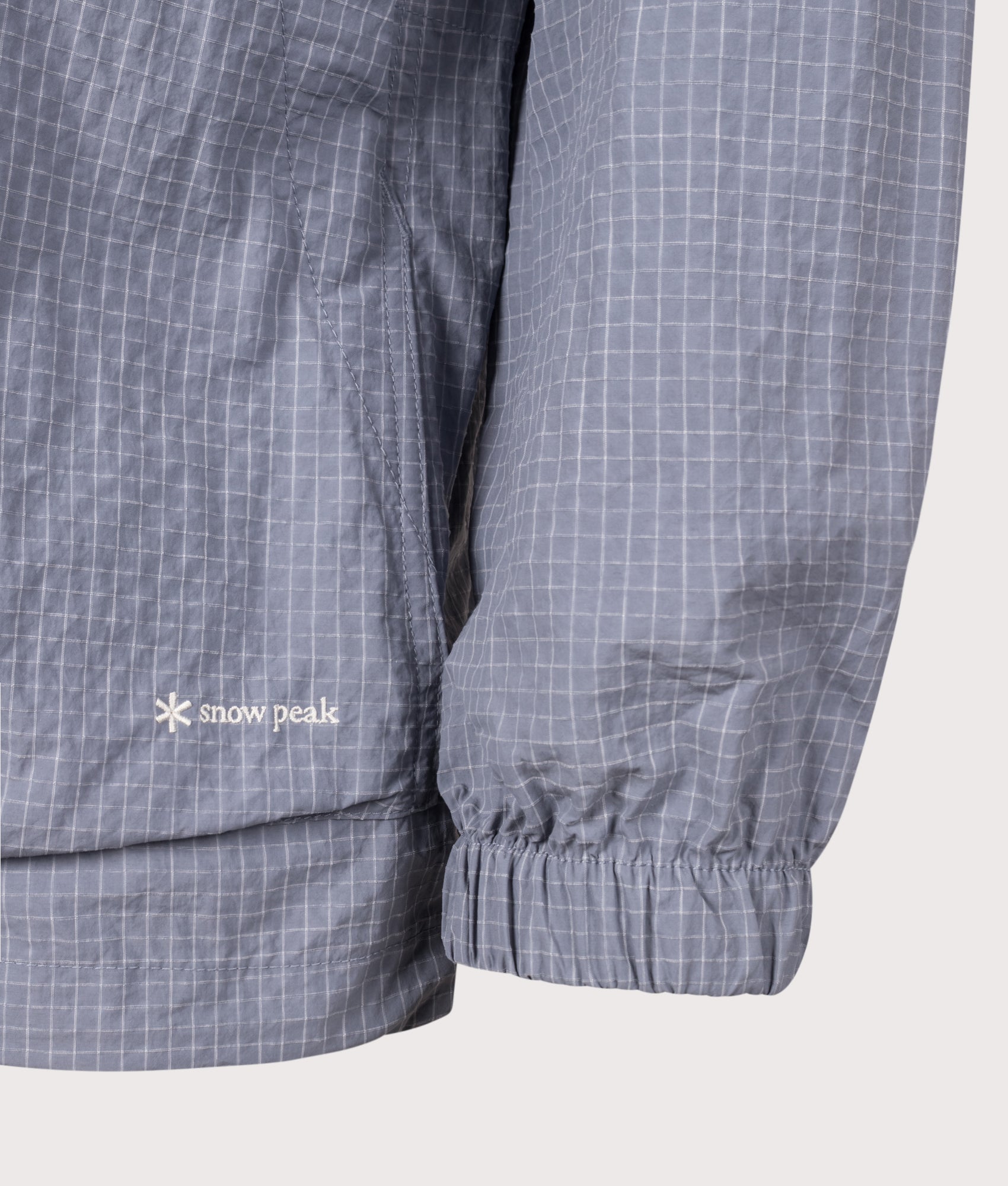 Snow Peak KASURI Ripstop Jacket in Light Blue at EQVVS Menswear. Detail shot.