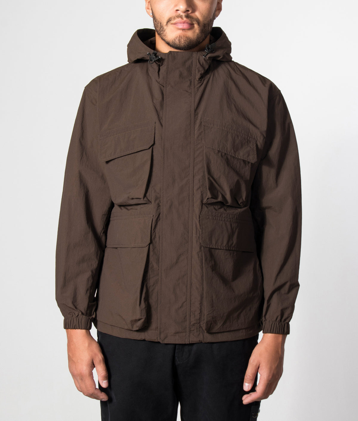 Snow Peak Regular Fit Nylon Double Rip Jacket in Dark Brown at EQVVS Menswear. Model front shot.