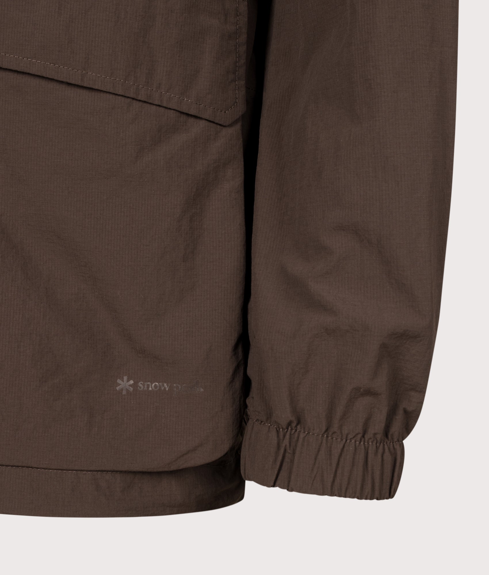 Snow Peak Regular Fit Nylon Double Rip Jacket in Dark Brown at EQVVS Menswear. Detail shot.