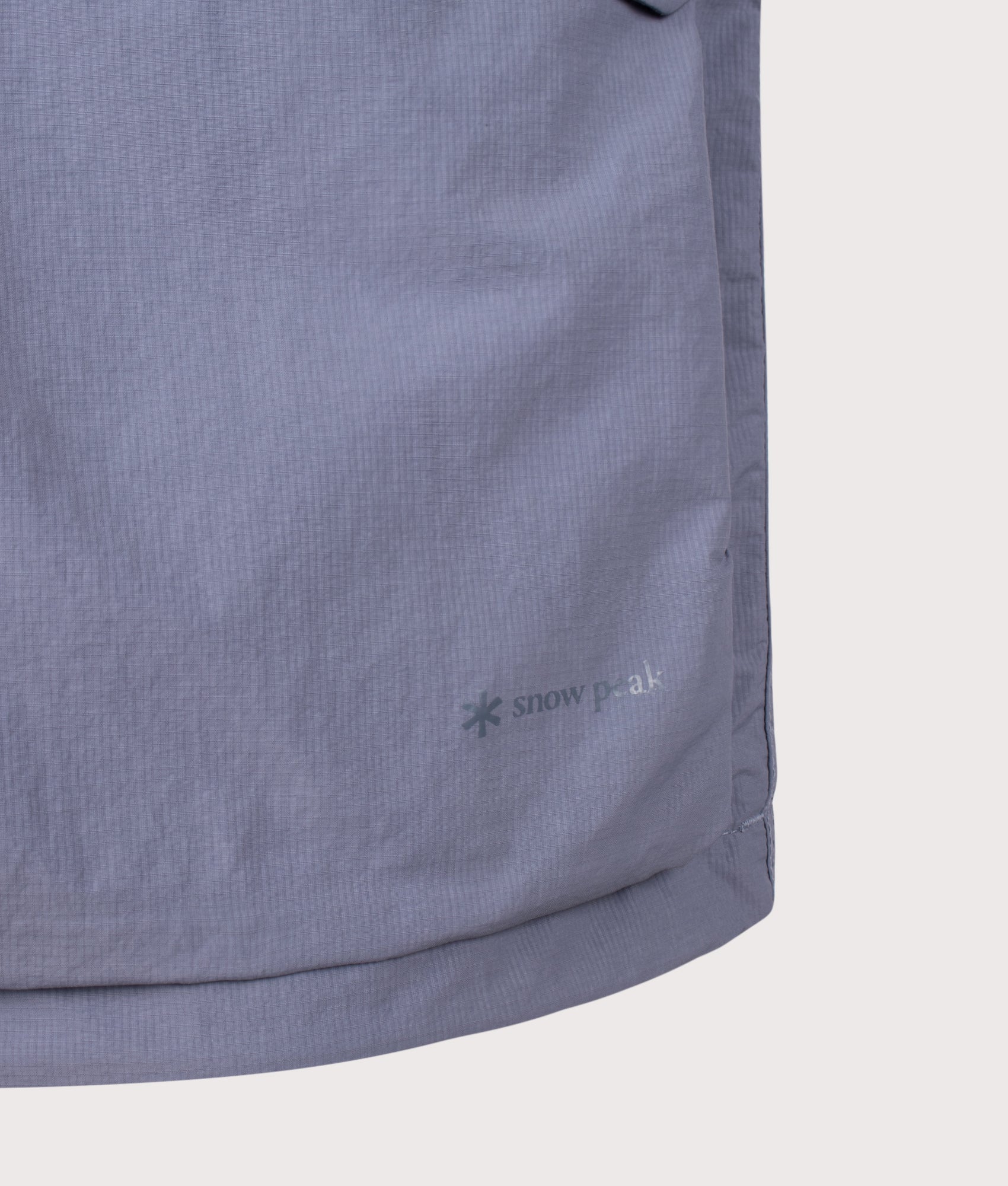 Snow Peak Regular Fit Nylon Double Rip Jacket in Light Blue at EQVVS Menswear. Detail shot.