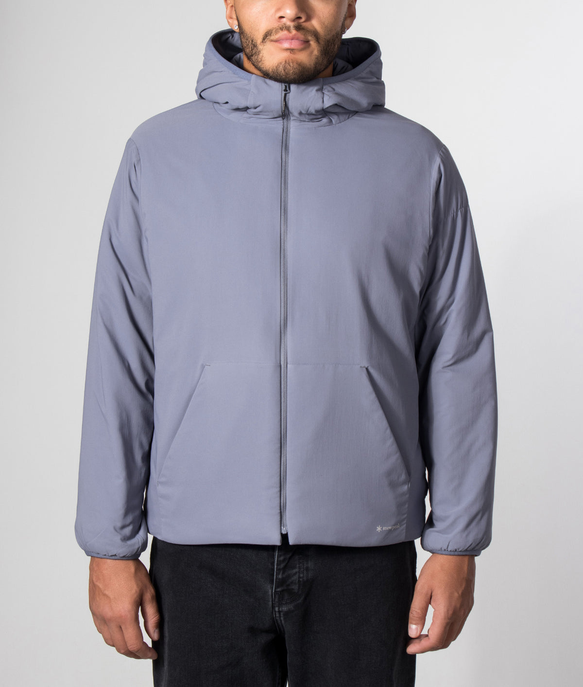 Snow Peak Regular Fit Flexible Insulated Zip Parka in Light Blue at EQVVS Menswear. Model front shot.