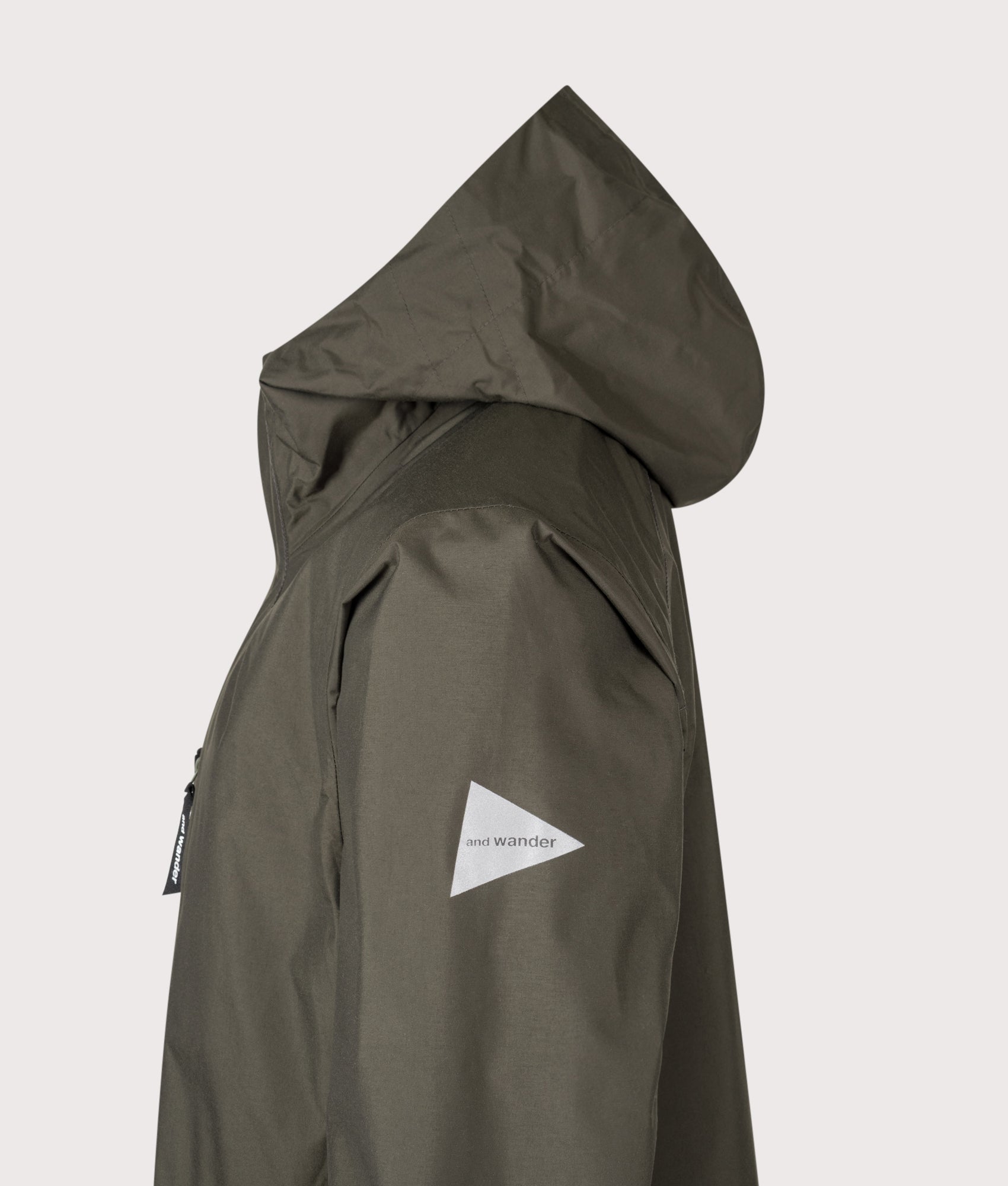 And Wander 2.5L Hiker Rain Jacket in Khaki at EQVVS Menswear. Side Detail shot.