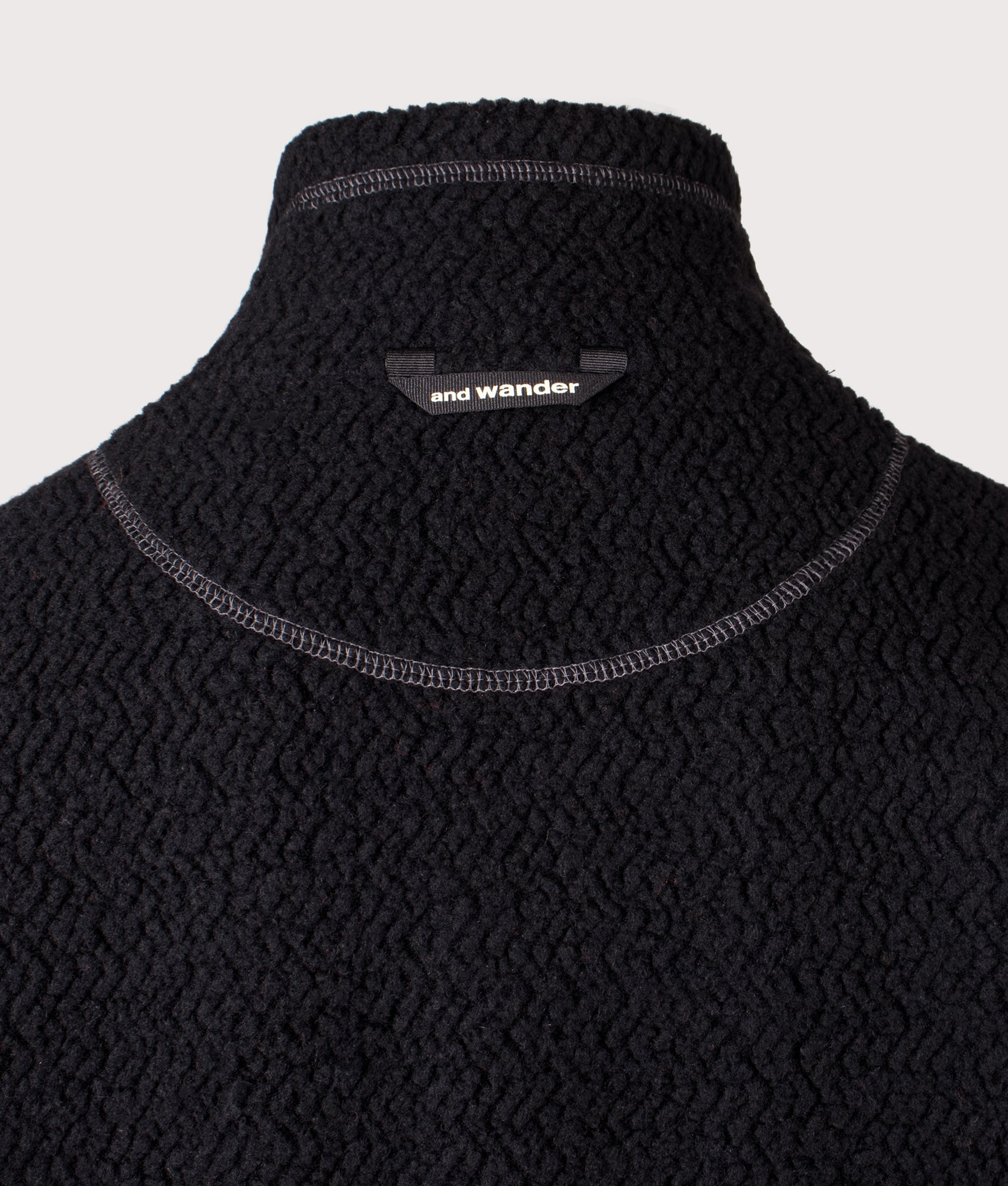 And Wander Re Wool JQ Stand Zip Sweatshirt in black at EQVVS Menswear. Back detail shot.