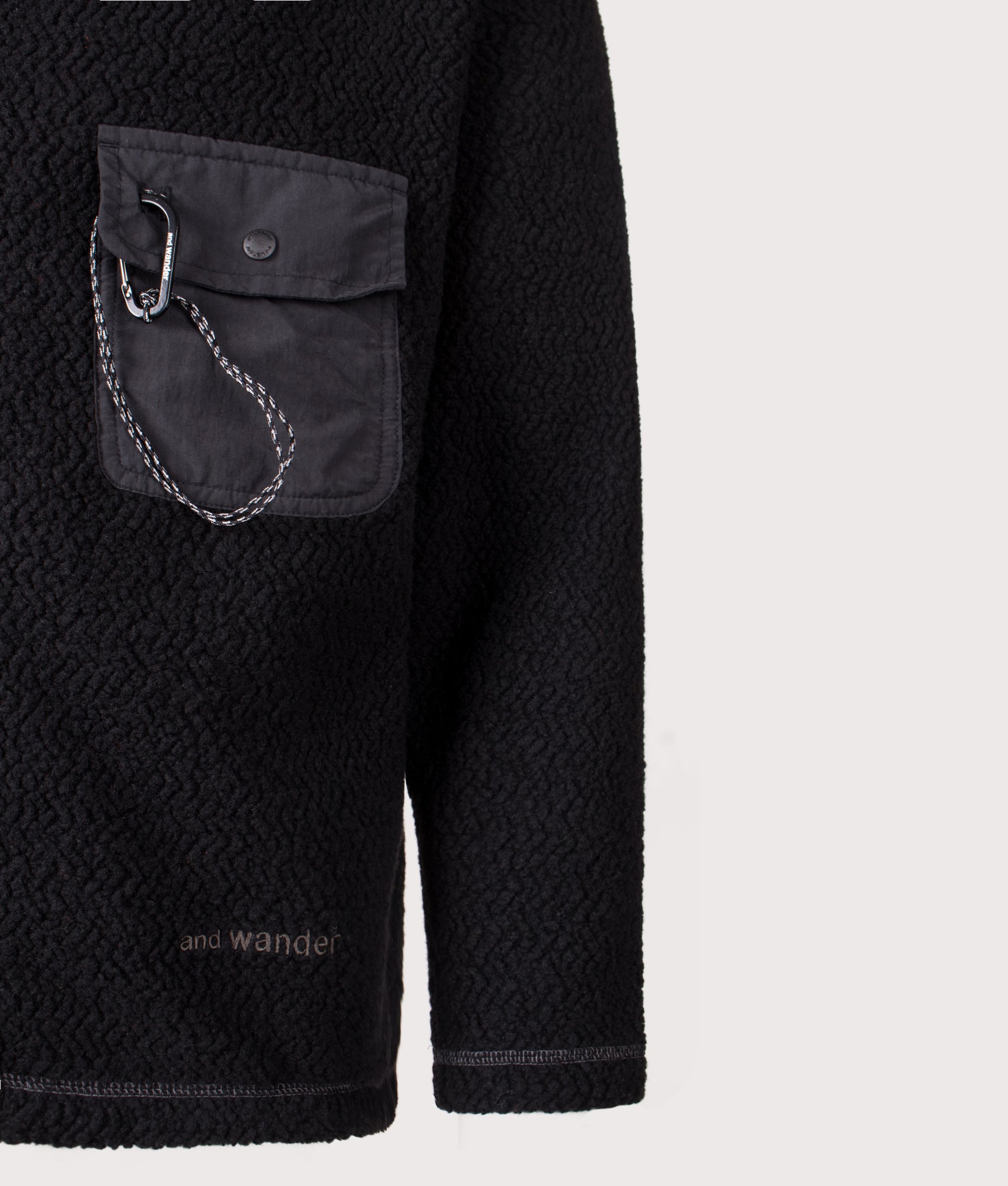 And Wander Re Wool JQ Stand Zip Sweatshirt in black at EQVVS Menswear. Detail shot.