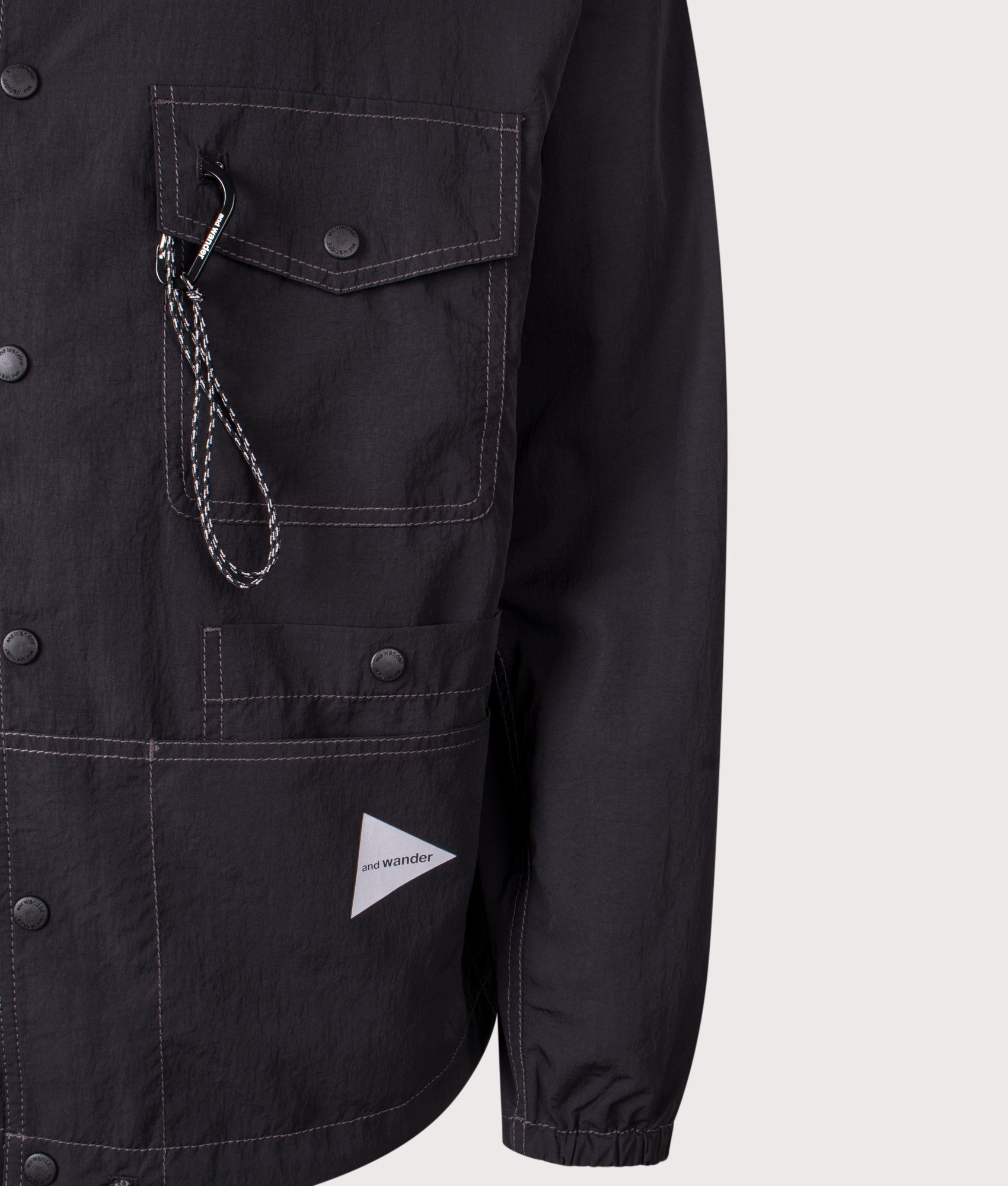 And Wander Crinkled Nylon Overshirt Jacket in Black at EQVVS Menswear. Detail shot.