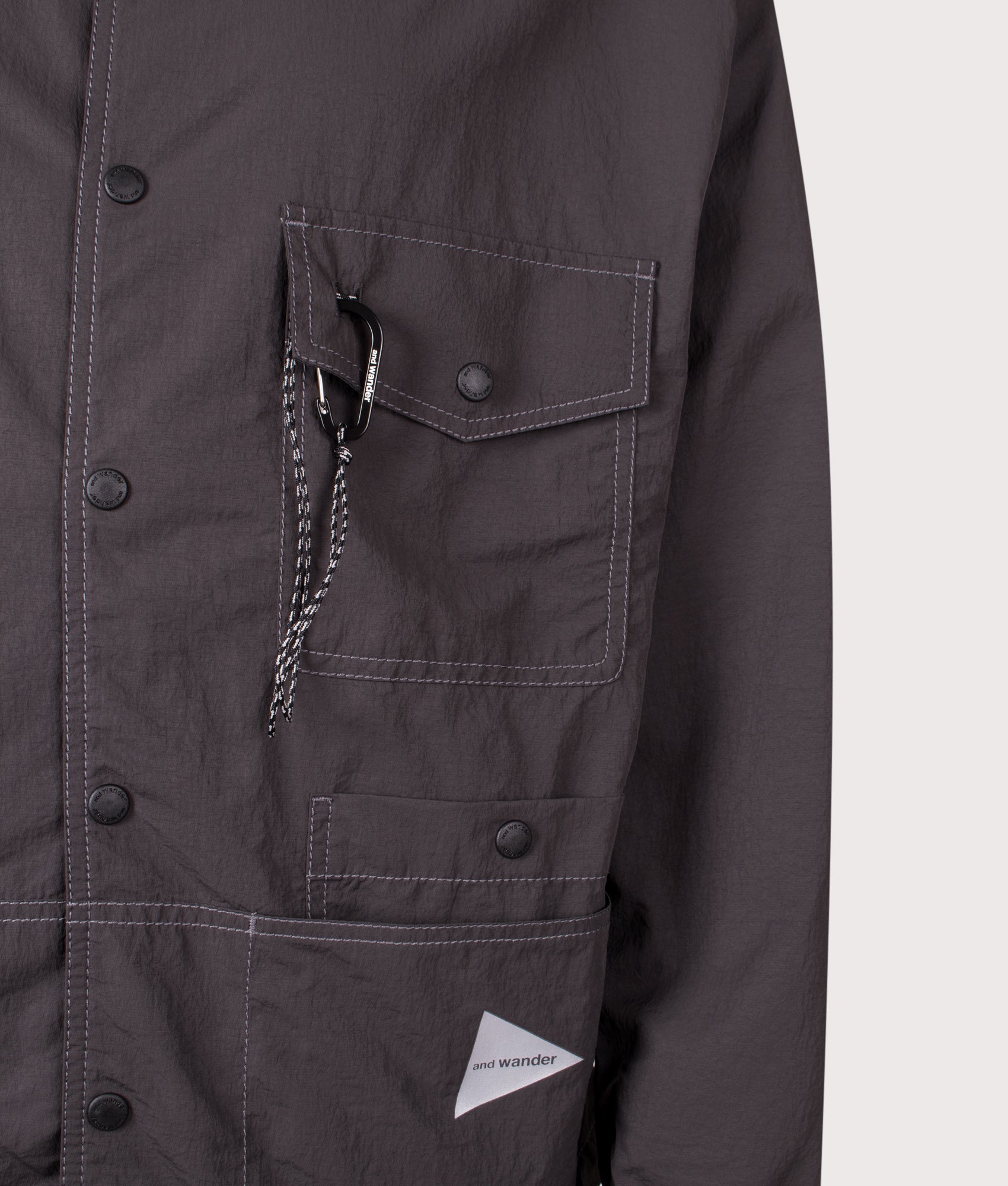 And Wander Crinkled Nylon Overshirt Jacket in Charcoal a EQVVS Menswear. Detail shot.