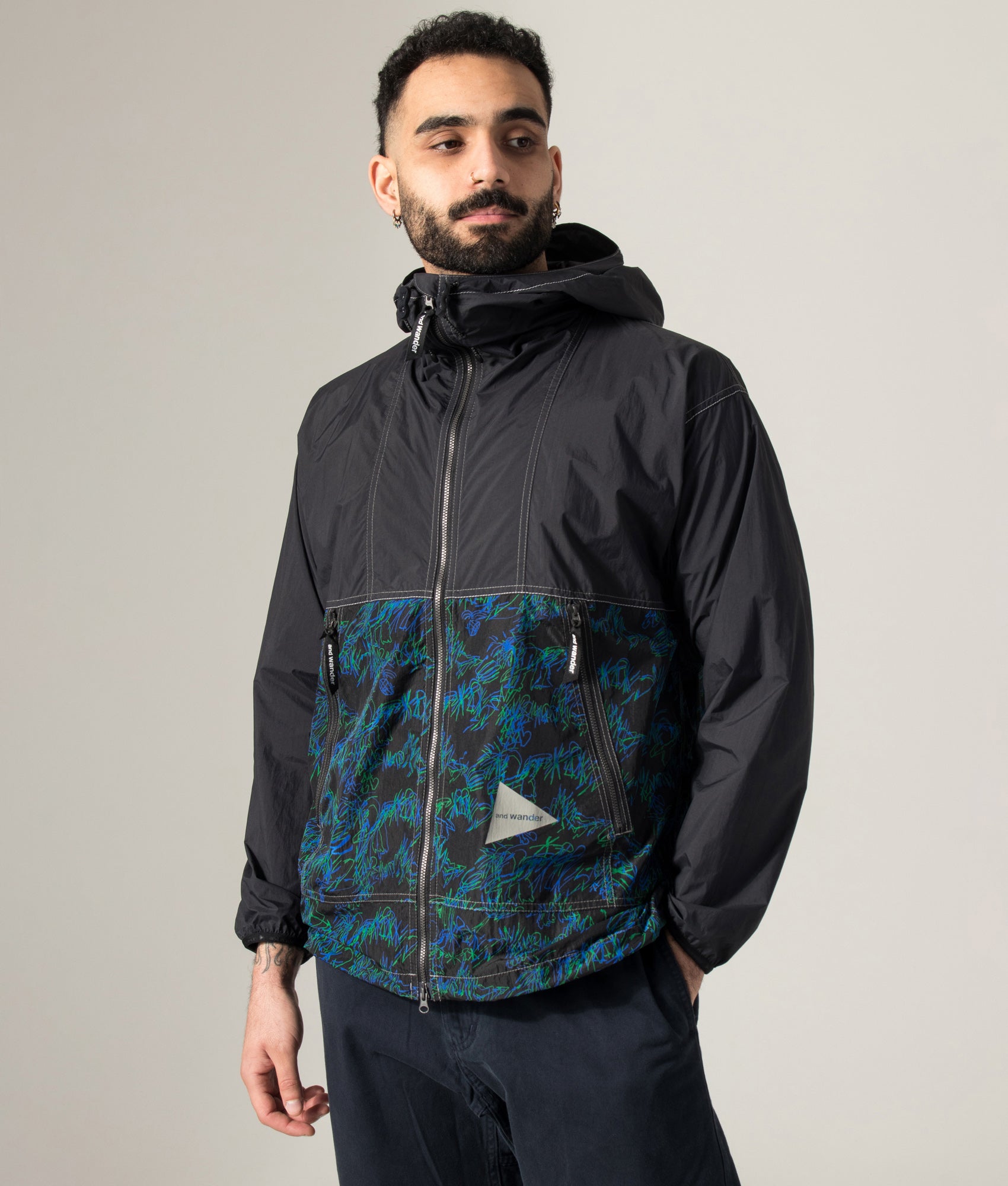 Printed Wind Jacket in Black by and wander. Shot by EQVVS. Model angled shot.