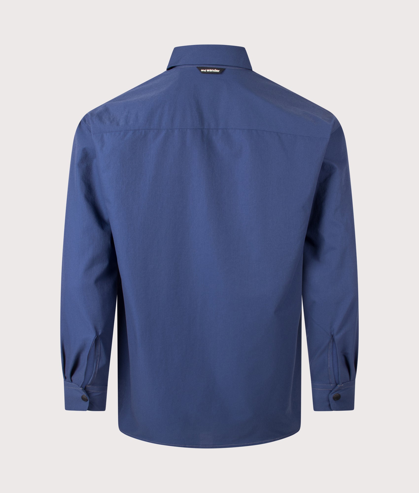 and wander Dry Breathable Shirt in Blue at EQVVS Menswear. Back shot.