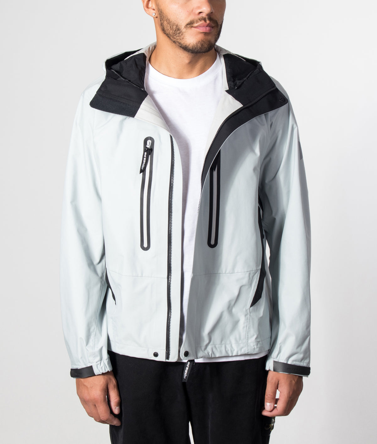 and wander 2.5L Hiker Rain Jacket in Light Gray at EQVVS Menswear. Model front shot.
