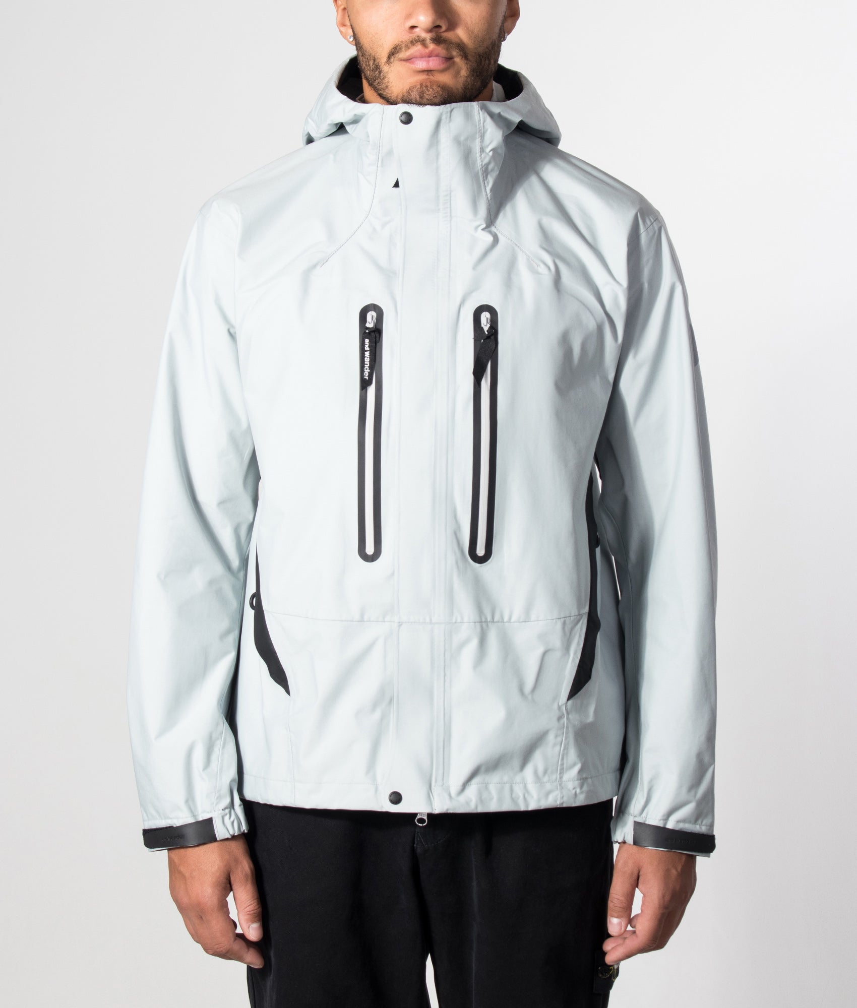 and wander 2.5L Hiker Rain Jacket in Light Gray at EQVVS Menswear. Model front shot.