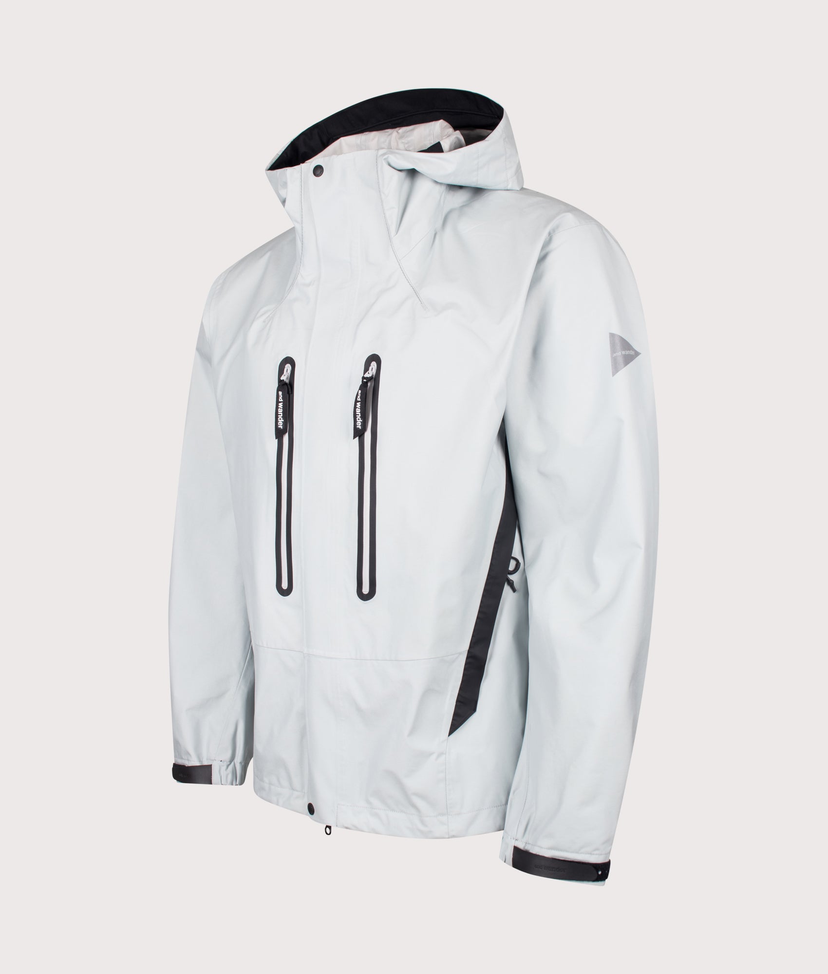 2.5L Hiker Rain Jacket in Light Grey by and wander. Shot by EQVVS. Front angled shot.