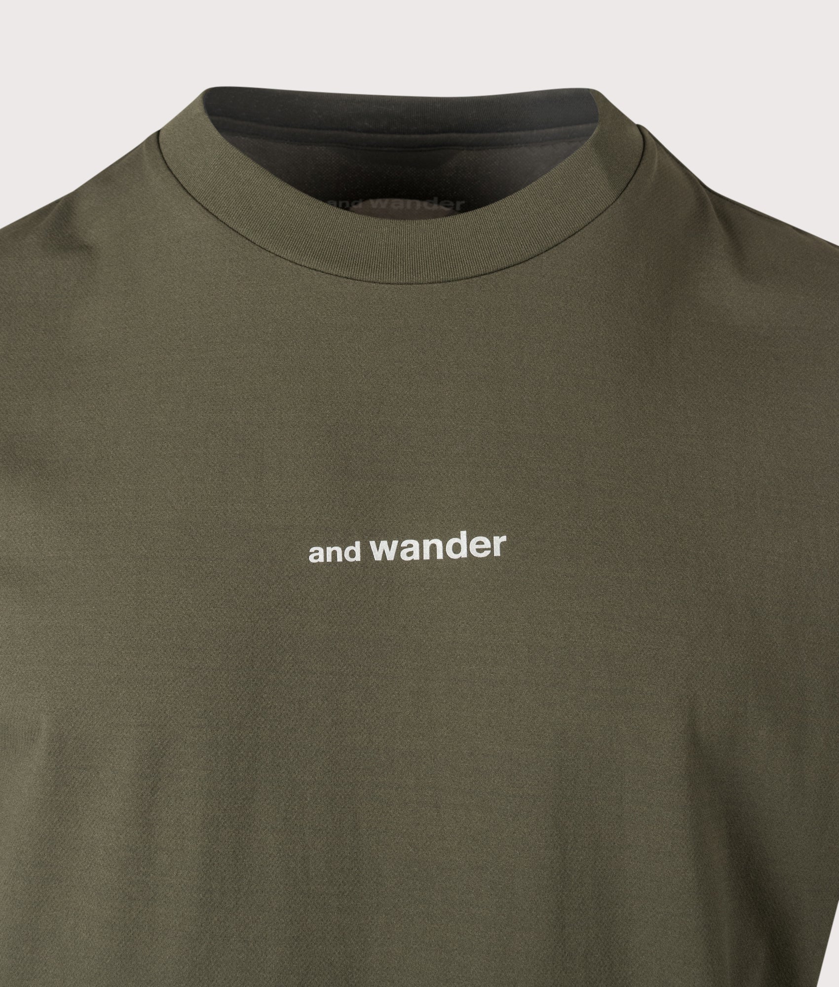 and wander Dry Mesh T-Shirt in Dark Khaki at EQVVS Menswear. Detail shot.