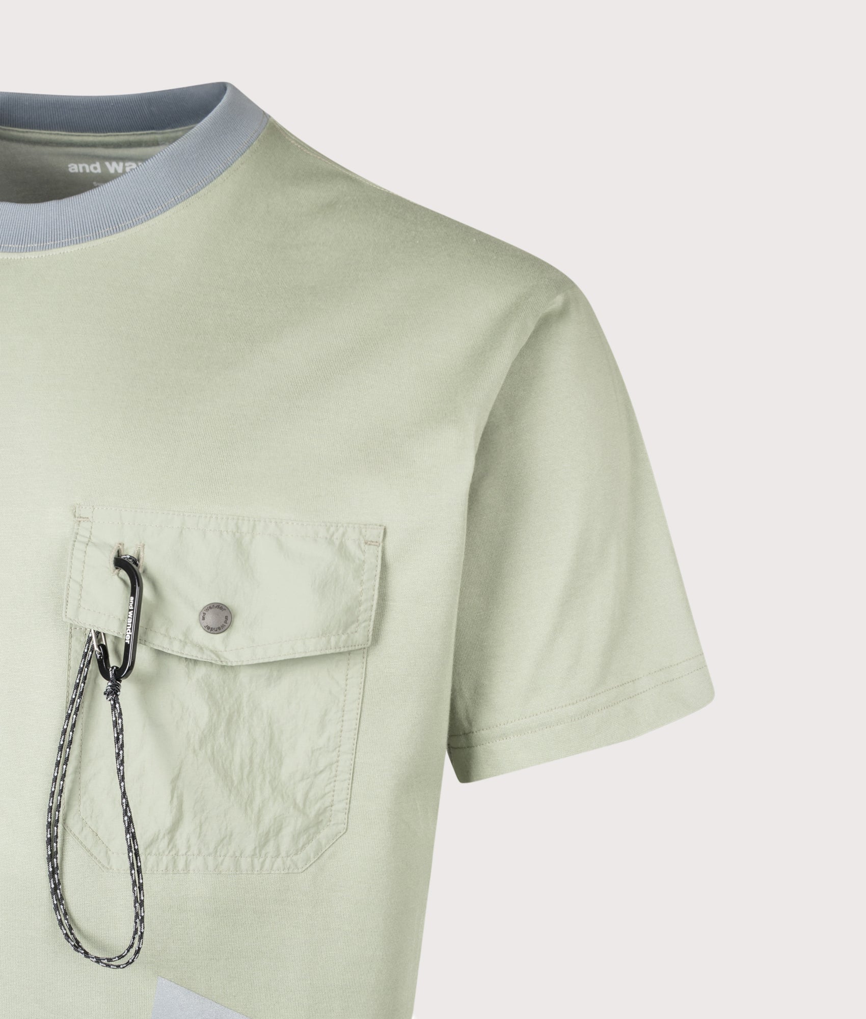 and wander Pocket T-Shirt in Light Sage at EQVVS Menswear. Detail shot.