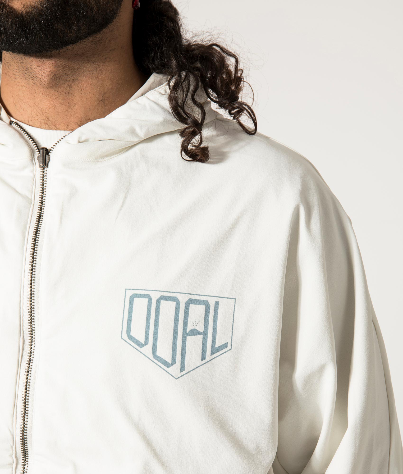 nanamica Reversible Hooded Jacket in Sand Beige. EQVVS Model Detail Shot.