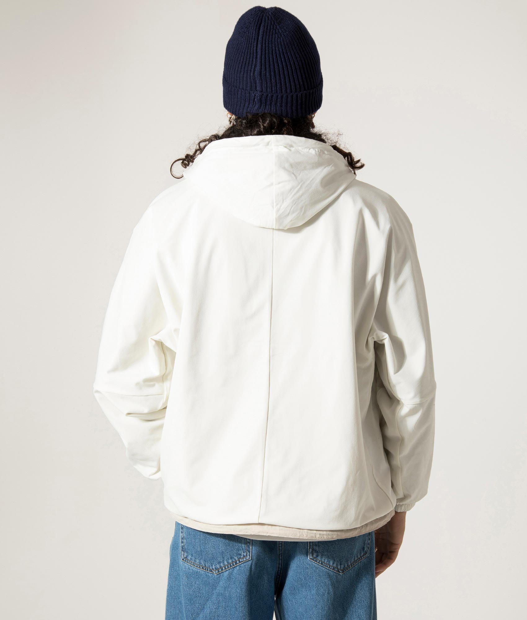 nanamica Reversible Hooded Jacket in Sand Beige. EQVVS Model Back Shot.