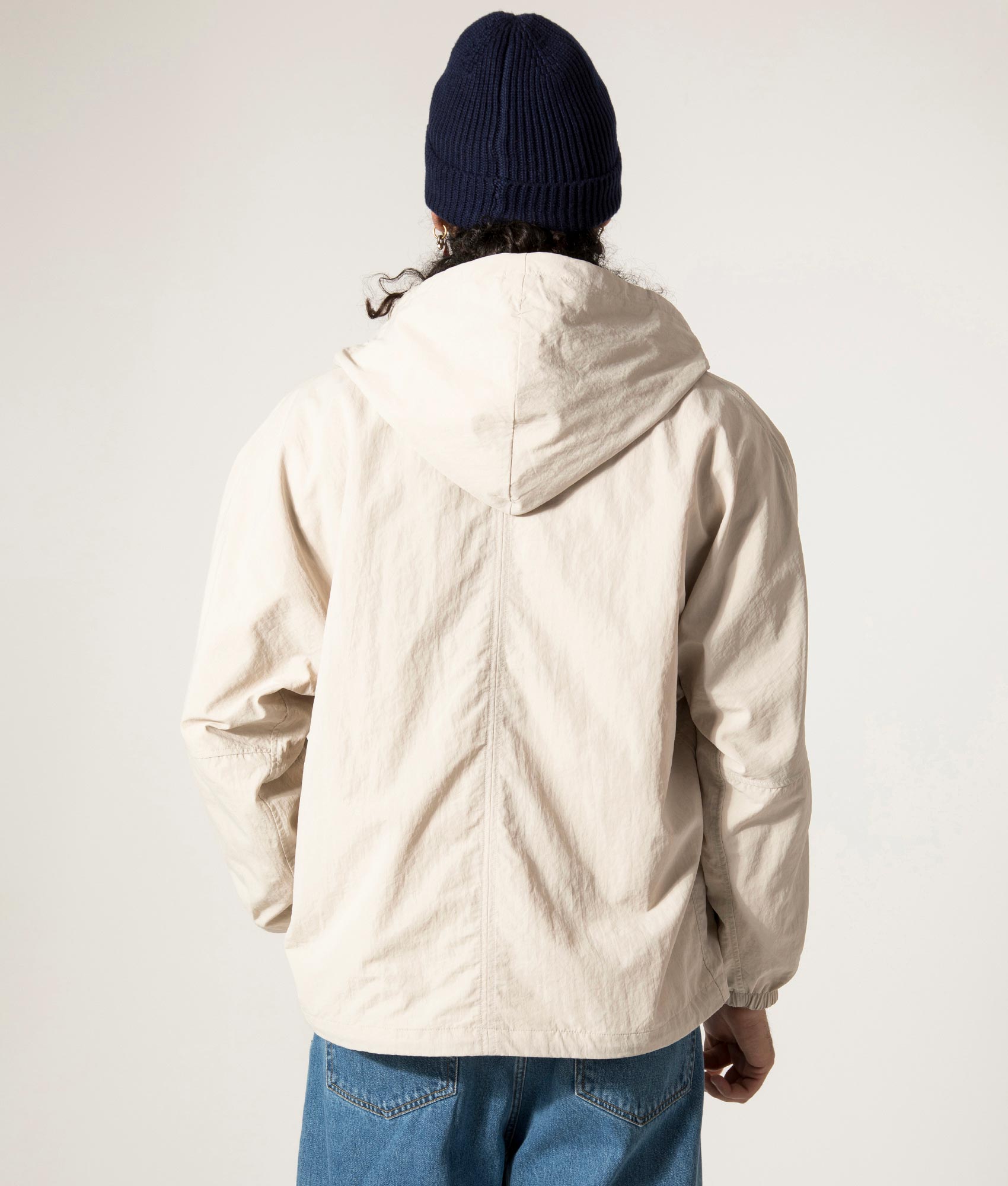 nanamica Reversible Hooded Jacket in Sand Beige. EQVVS Model Back Shot.