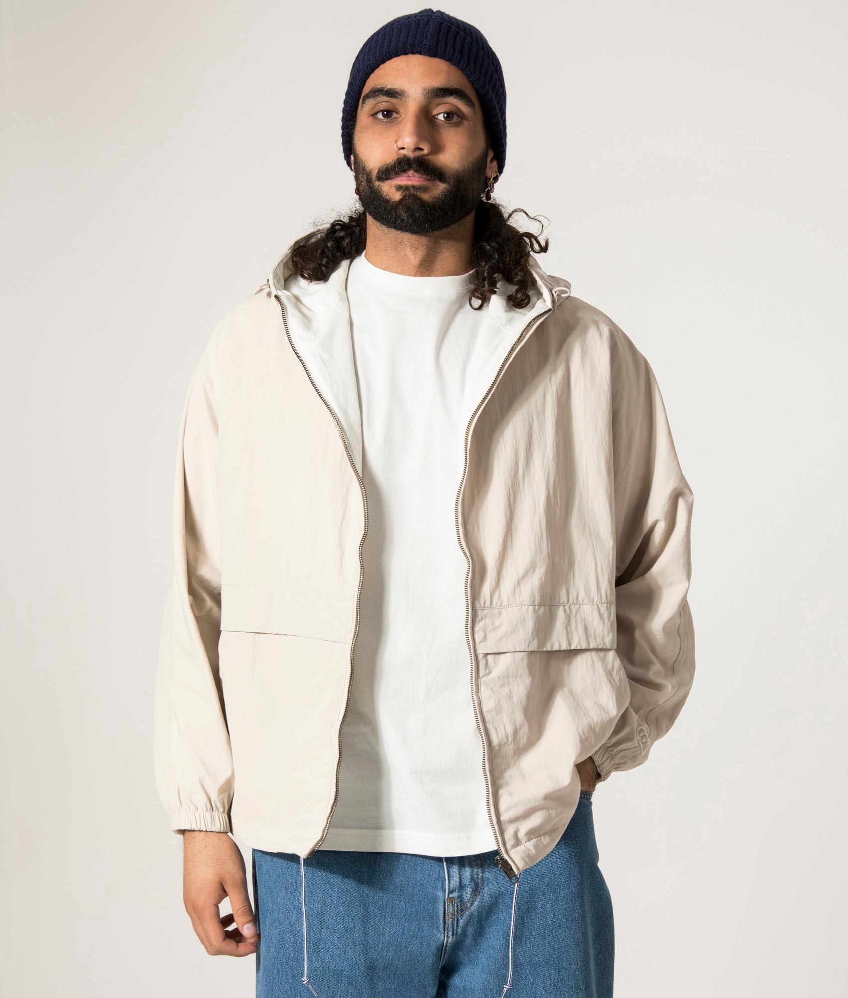 nanamica Reversible Hooded Jacket in Sand Beige. EQVVS Model Front Shot.