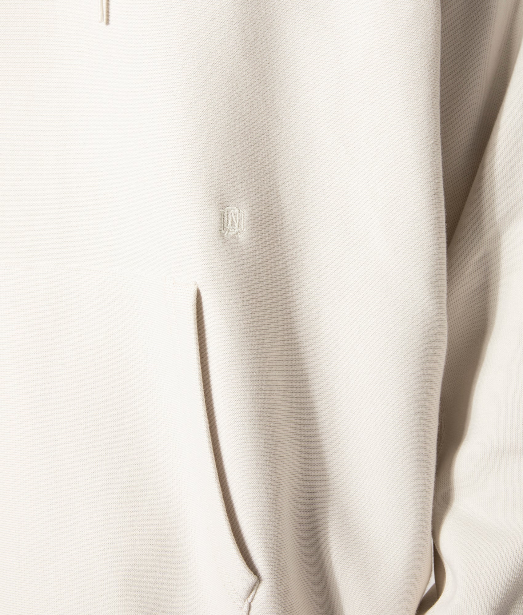 nanamica Hooded Pullover Sweat in Ivory at EQVVS. Model Detail Shot.