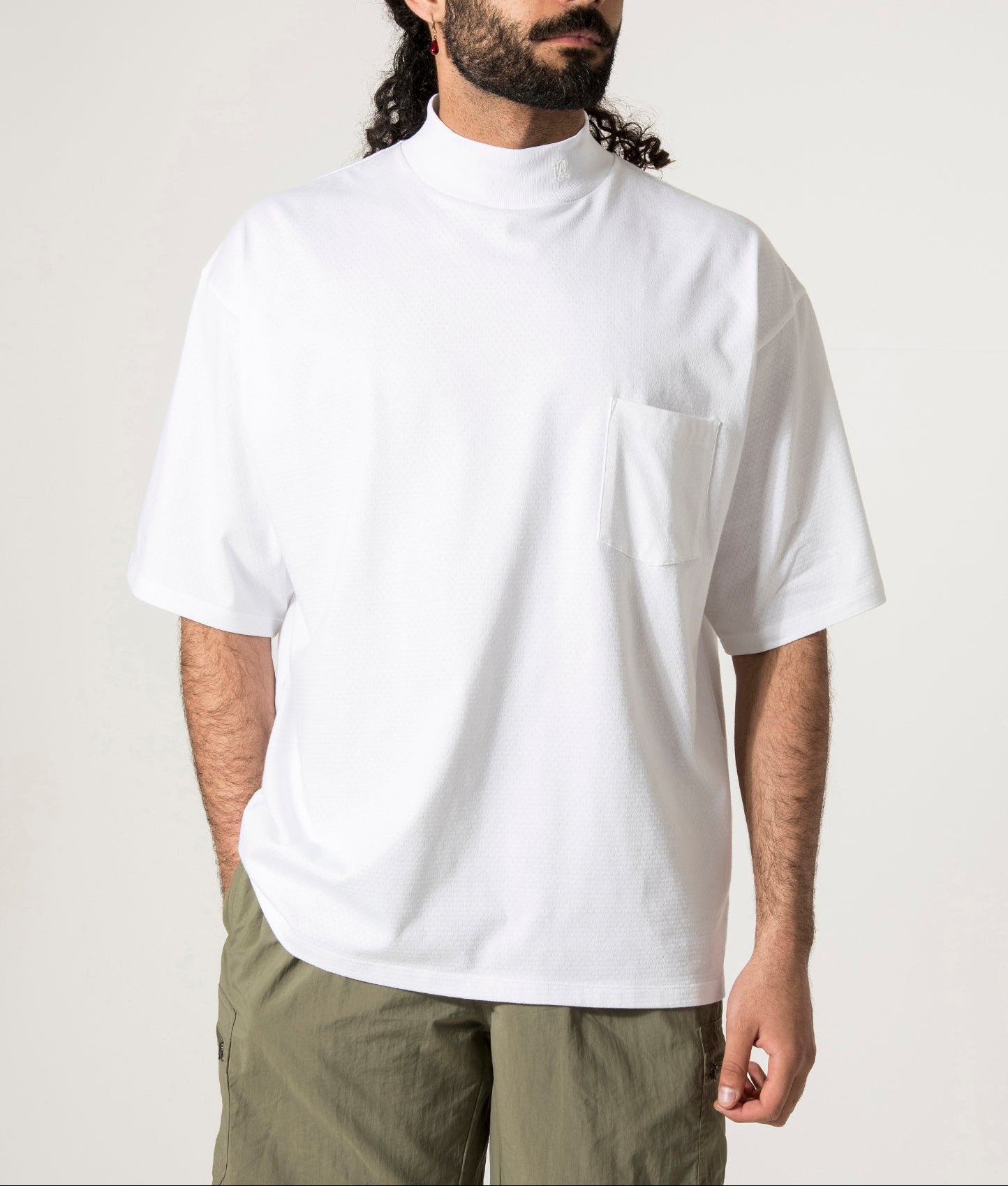 nanamica Mock Neck T-Shirt in white at EQVVS. Model Front Shot.