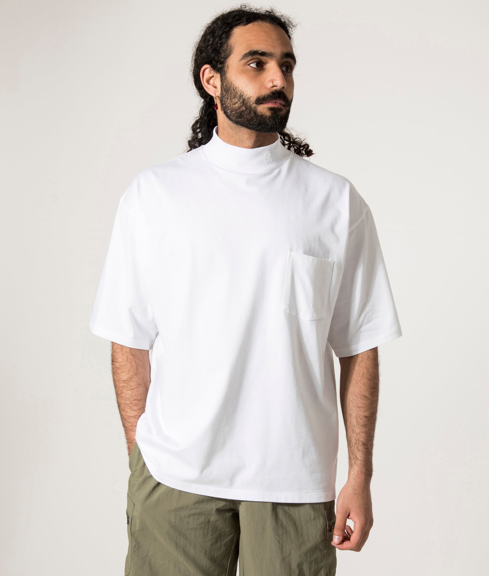 nanamica Mock Neck T-Shirt in white at EQVVS. Model Front Shot.