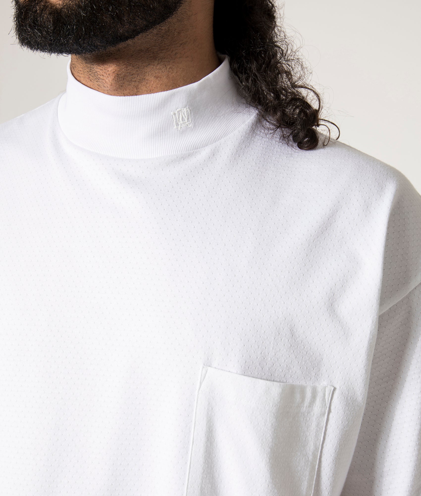 nanamica Mock Neck T-Shirt in white at EQVVS. Model Detail Shot.