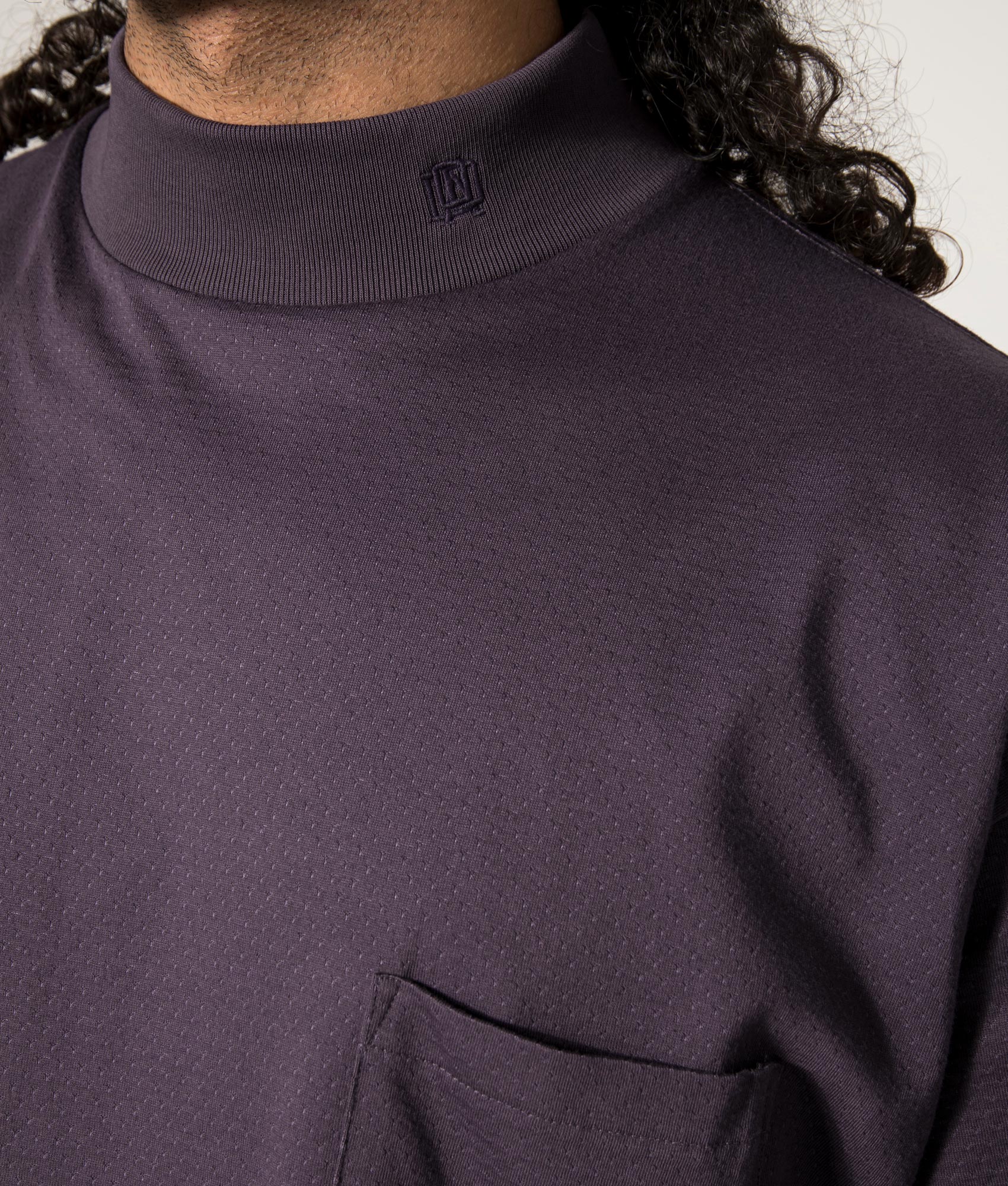 nanamica Mock Neck T-Shirt in Vintage Navy at EQVVS. Front Model Detail Shot.