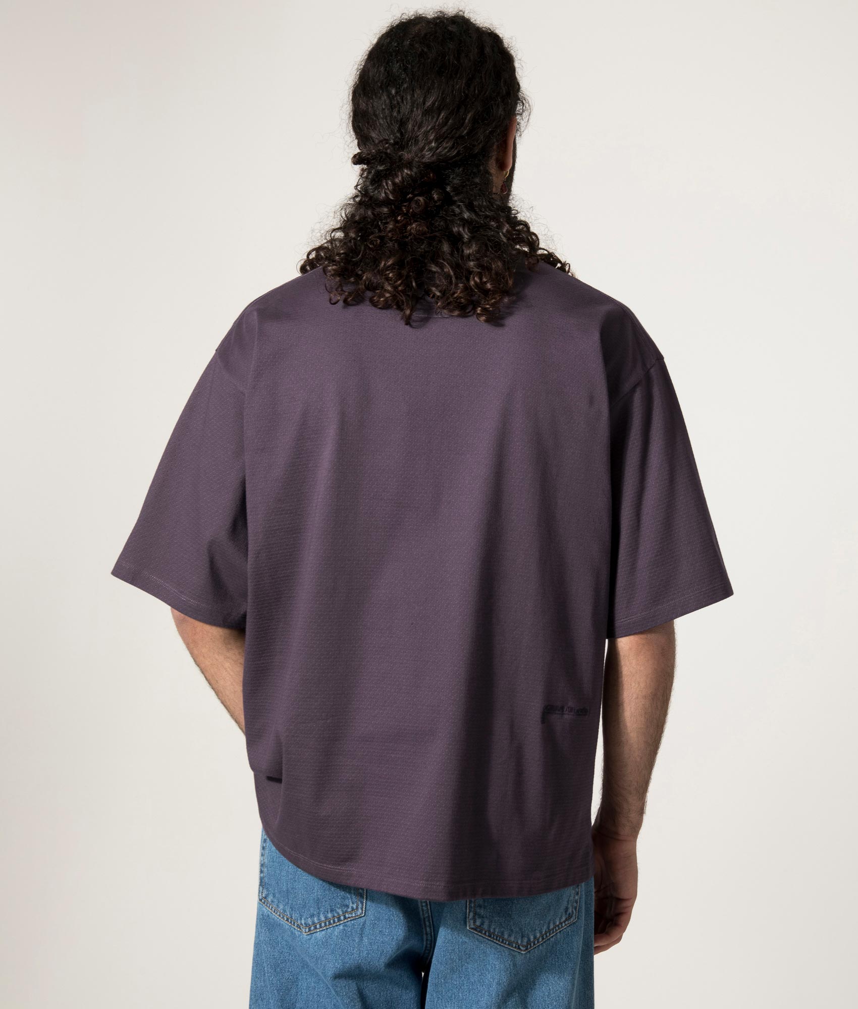 nanamica Mock Neck T-Shirt in Vintage Navy at EQVVS. Model Back Shot.