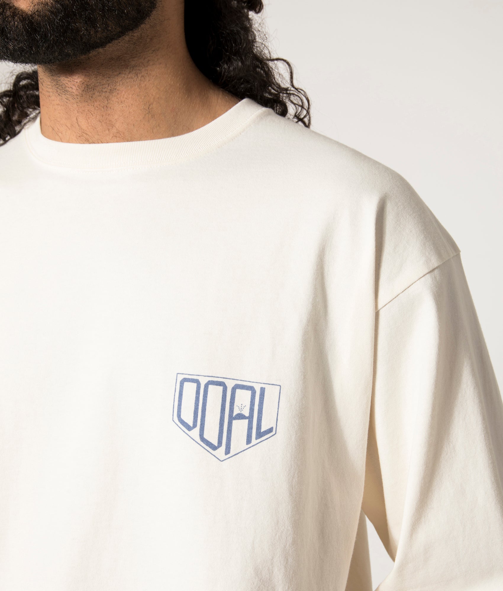  nanamica OOAL Long Sleeve Graphic T-Shirt in Ivory at EQVVS. Model Front DetailShot.
