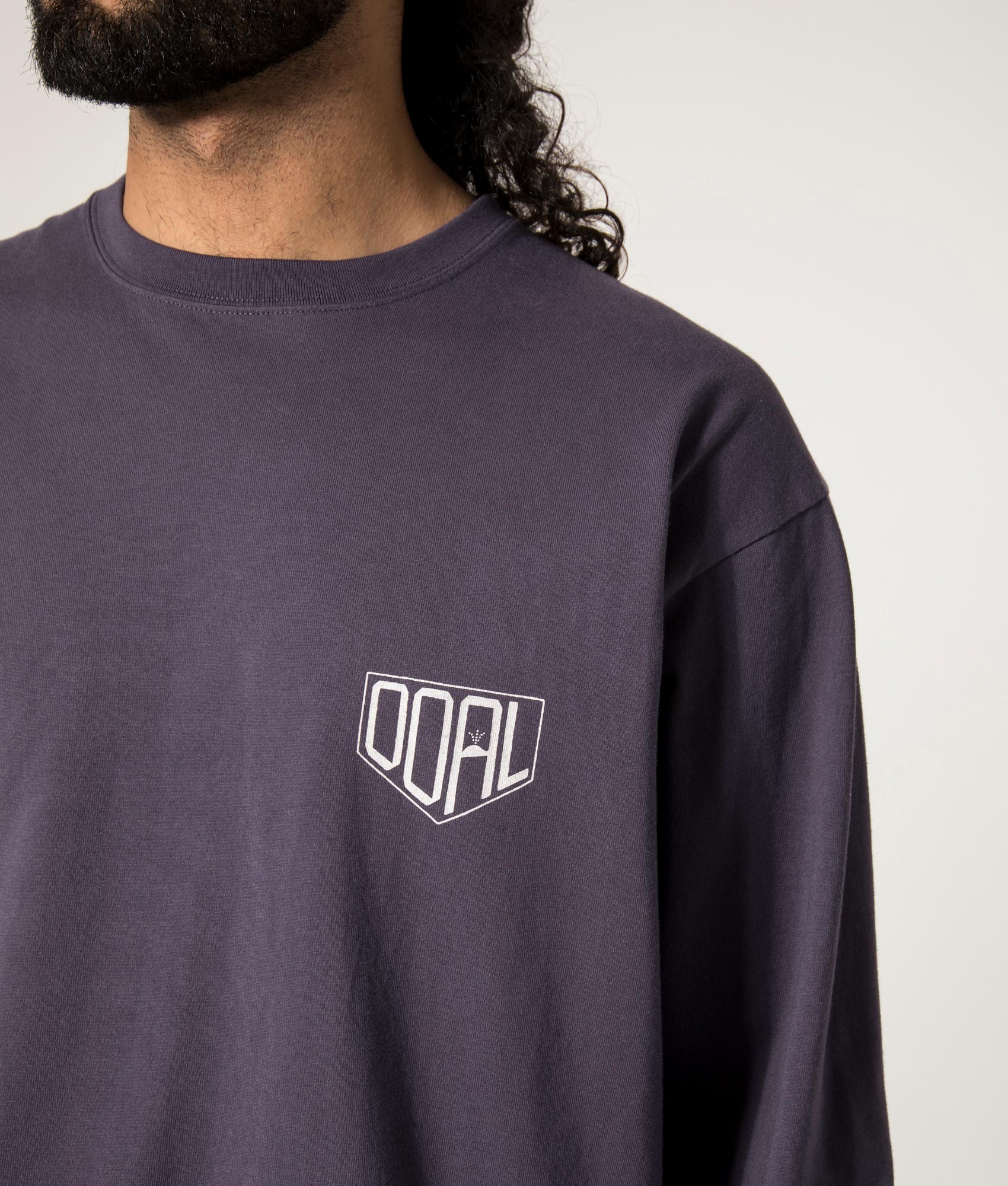 nanamica OOAL Long Sleeve Graphic T-Shirt in Vintage Navy at EQVVS. Front Model Detail Shot.