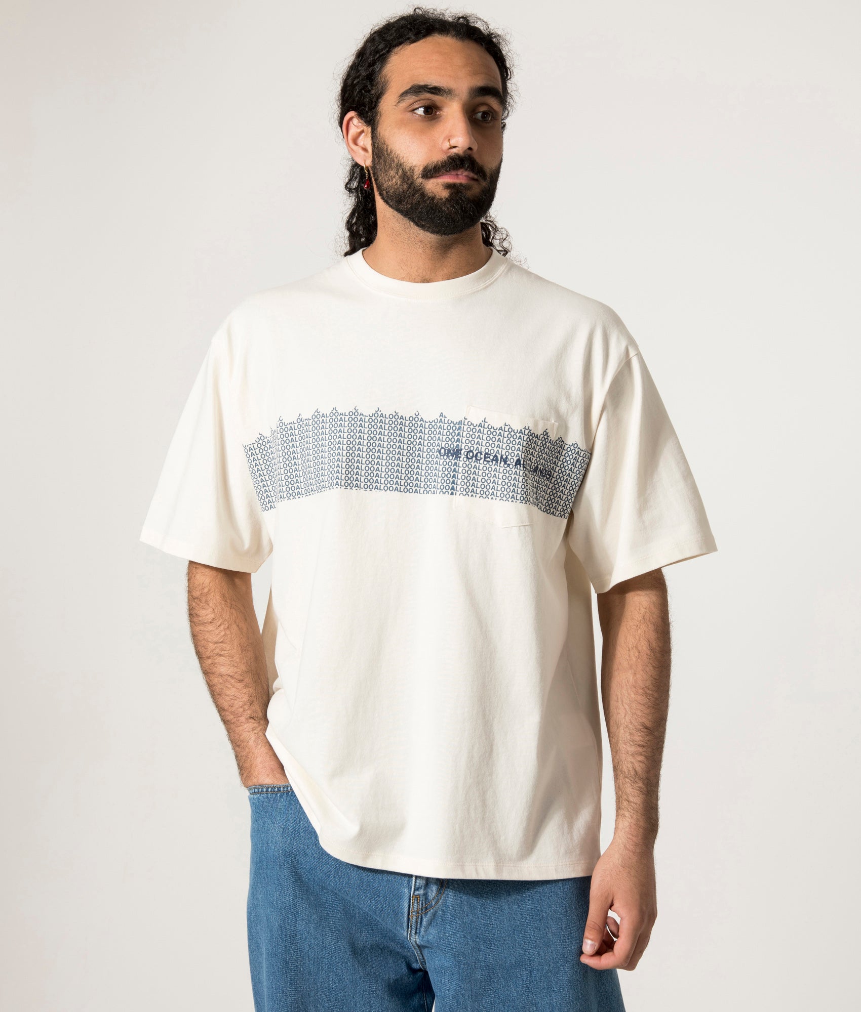 nanamica OOAL Graphic T-Shirt in Ivory at EQVVS. Model Front Shot.