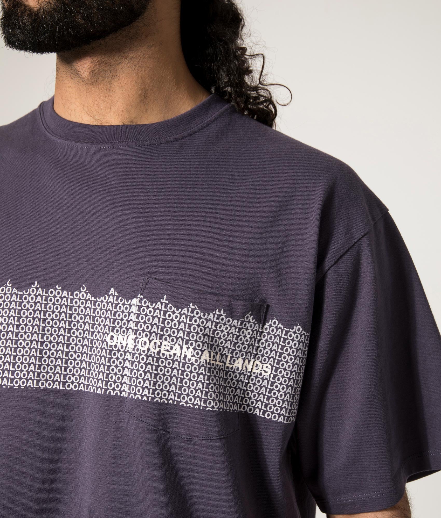 nanamica OOAL Graphic T-Shirt in Vintage Blue at EQVVS. Model Detail Front Shot.